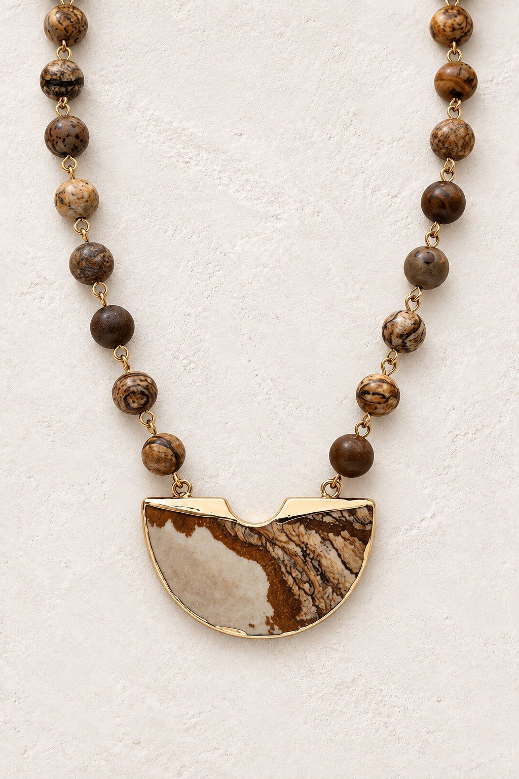 Dahara Desert Jasper beaded half-moon statement necklace on a neutral background