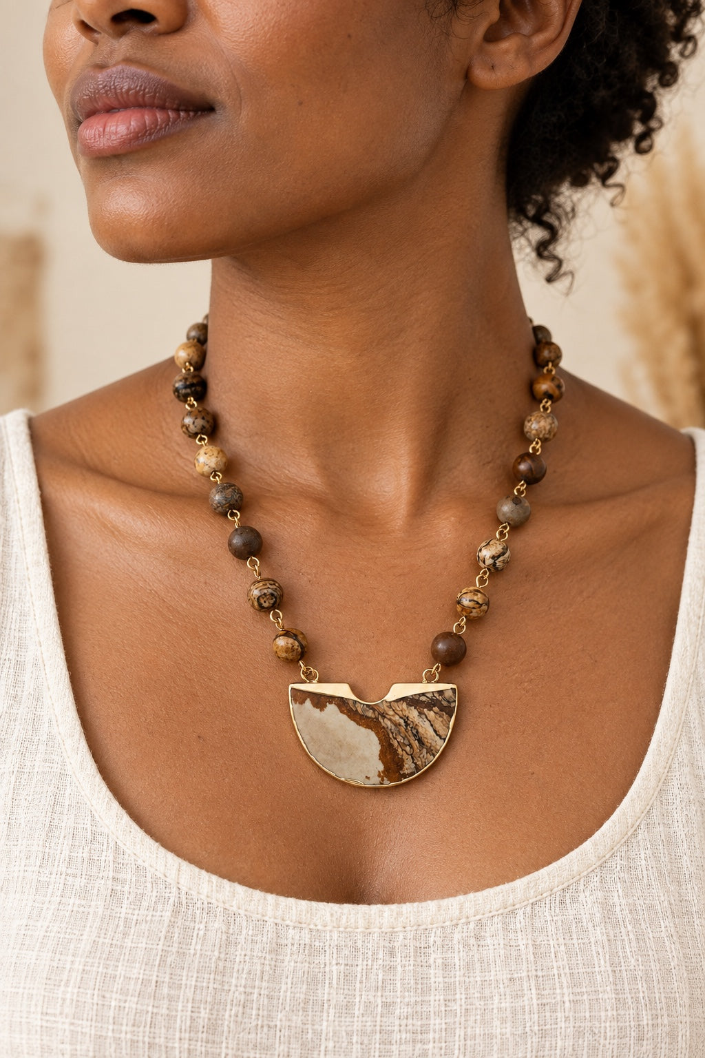 Boho model wearing the Dahara Desert Jasper half-moon statement necklace