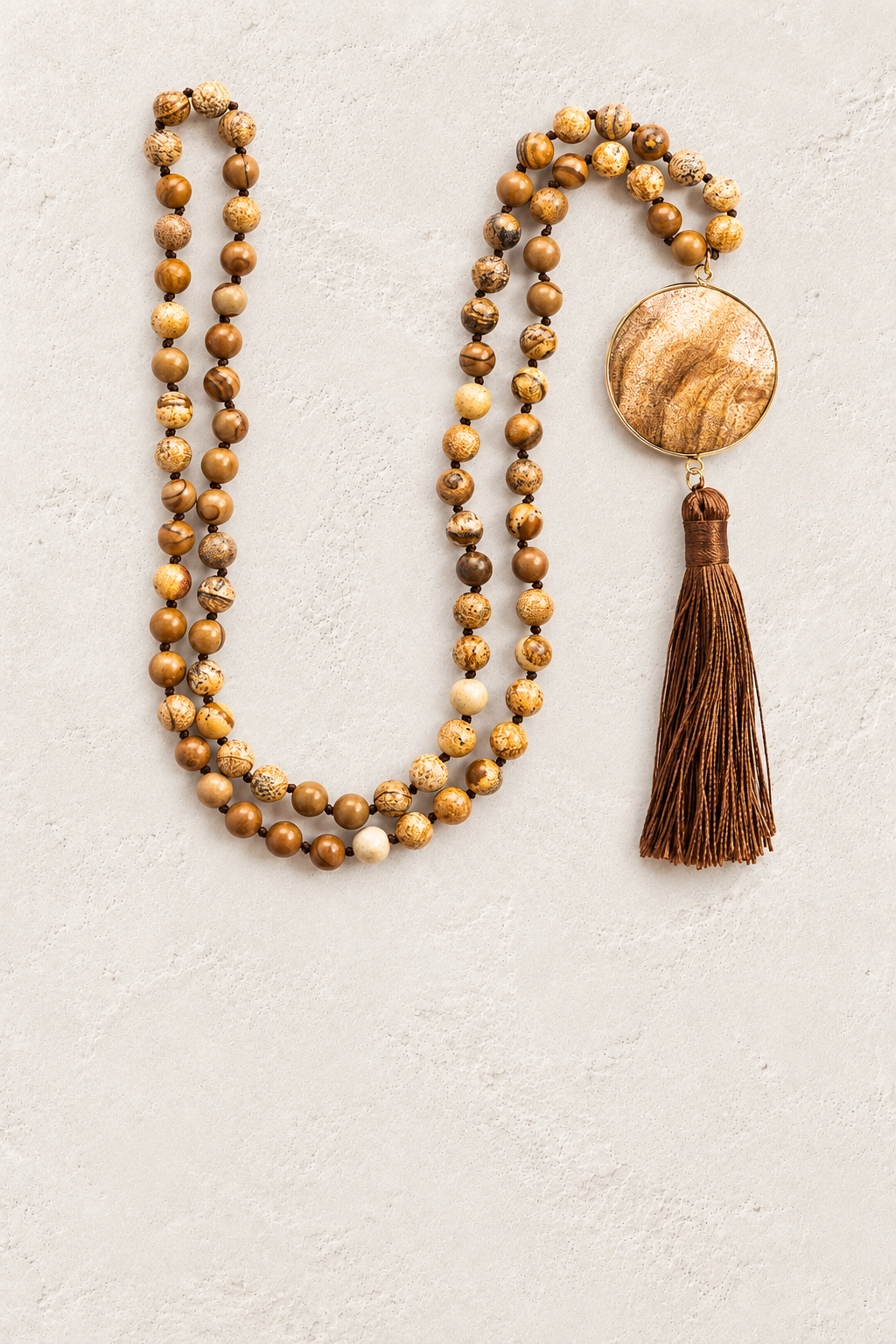 
                  
                    Desert Jasper Tassel Necklace on warm ivory plaster background
                  
                