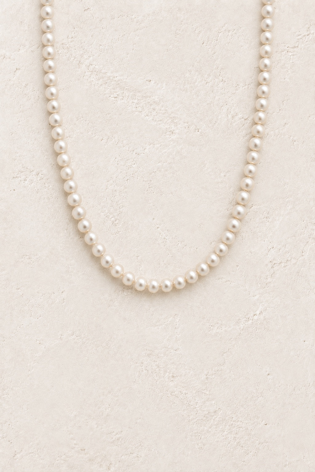 Elodie classic freshwater pearl strand necklace on a neutral background