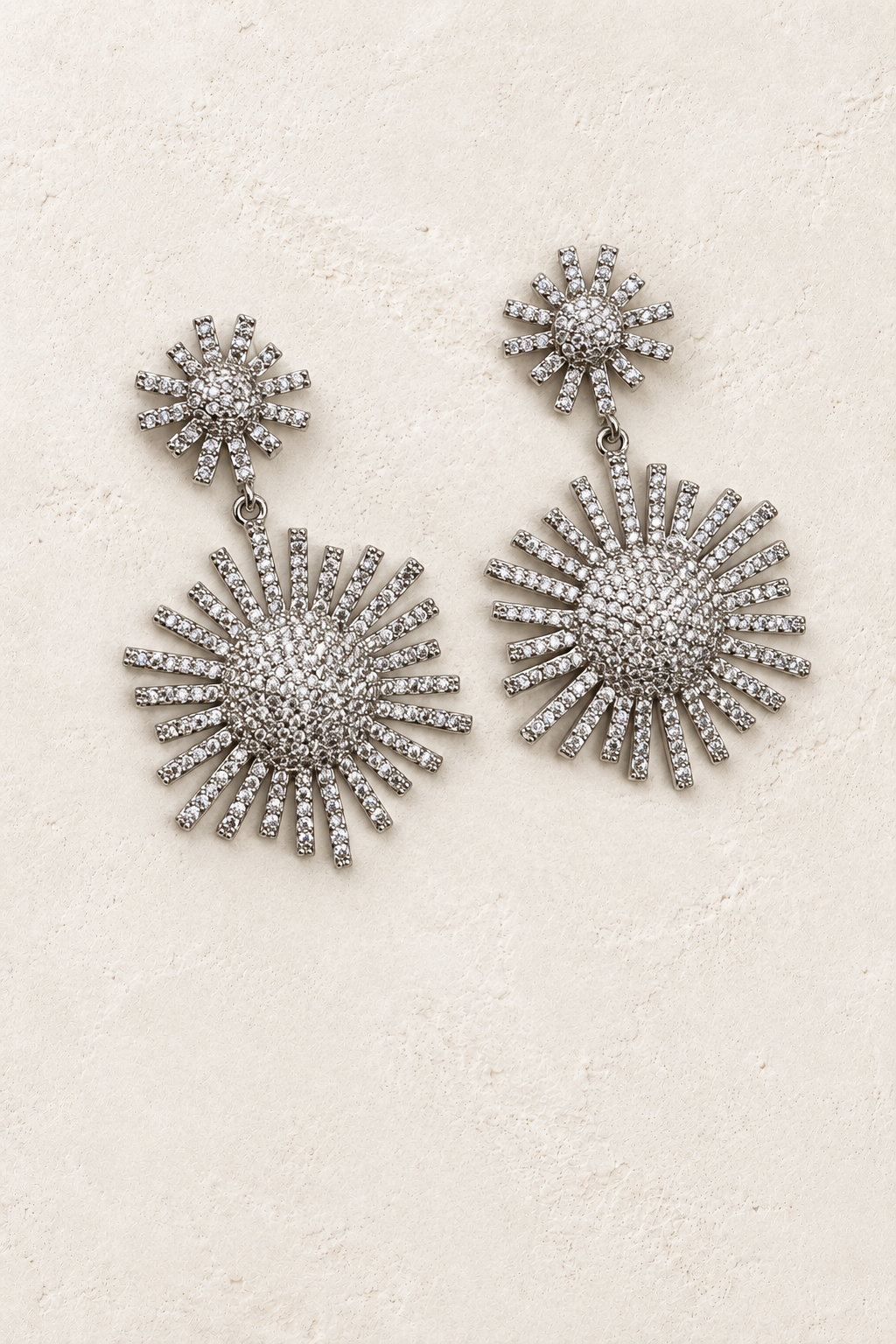 
                  
                    Elysia Silver Crystal Stud Drop Earrings – Sparkling Statement Earrings on warm ivory plaster
                  
                