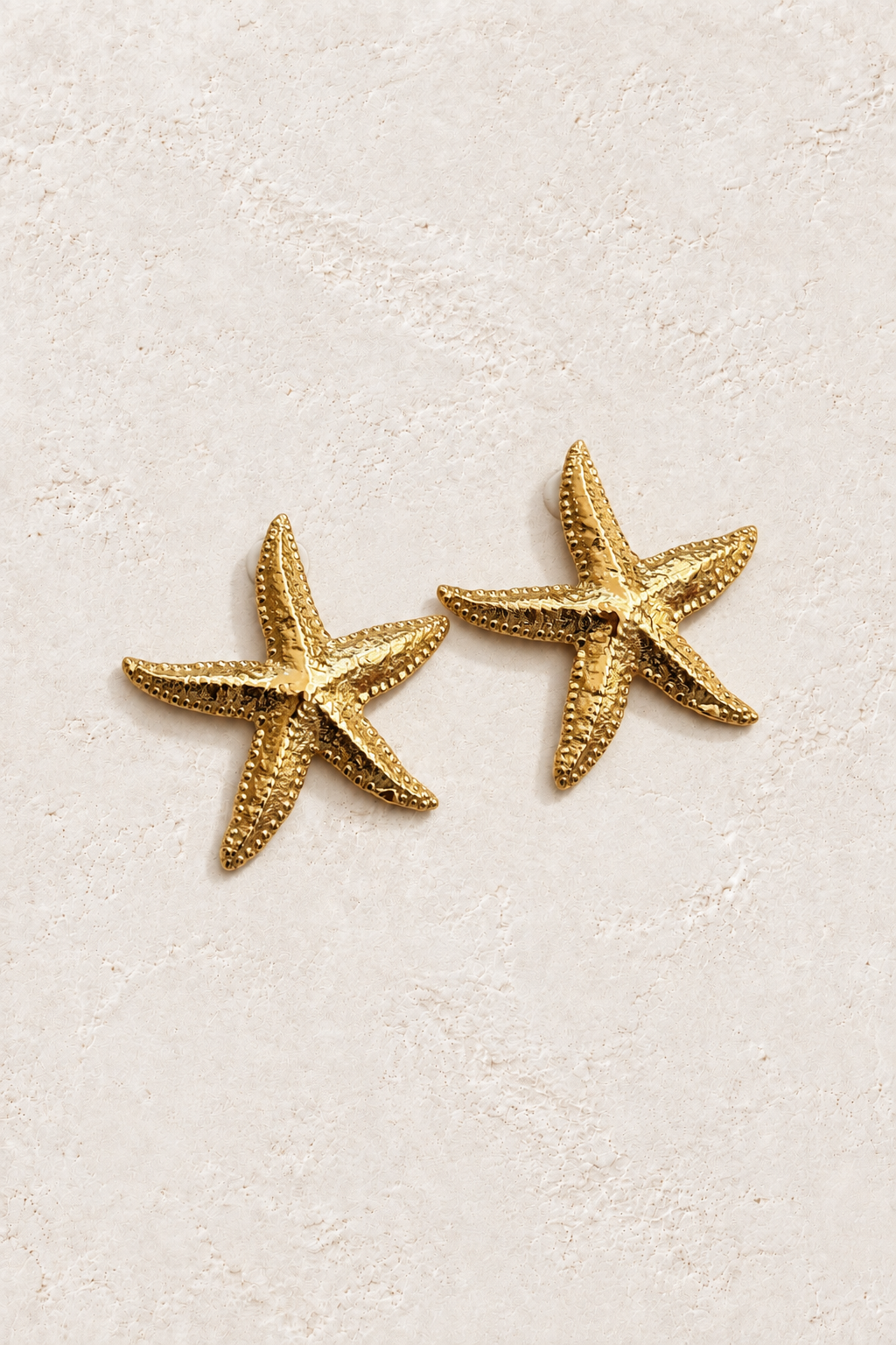 Estelle Starfish Studs on warm ivory textured background