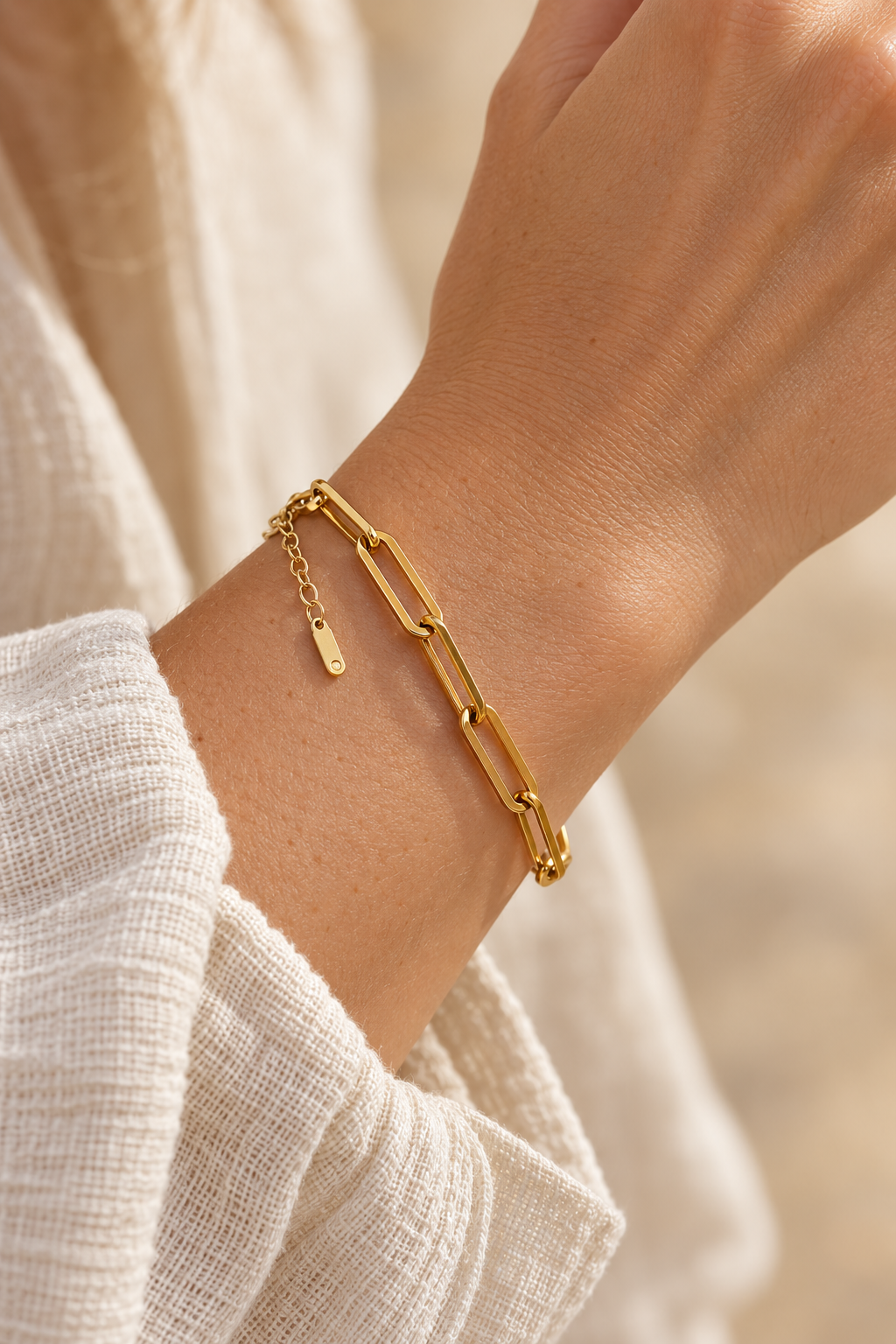 
                  
                    Greta Gold Long Paperclip Bracelet worn on a model's wrist
                  
                