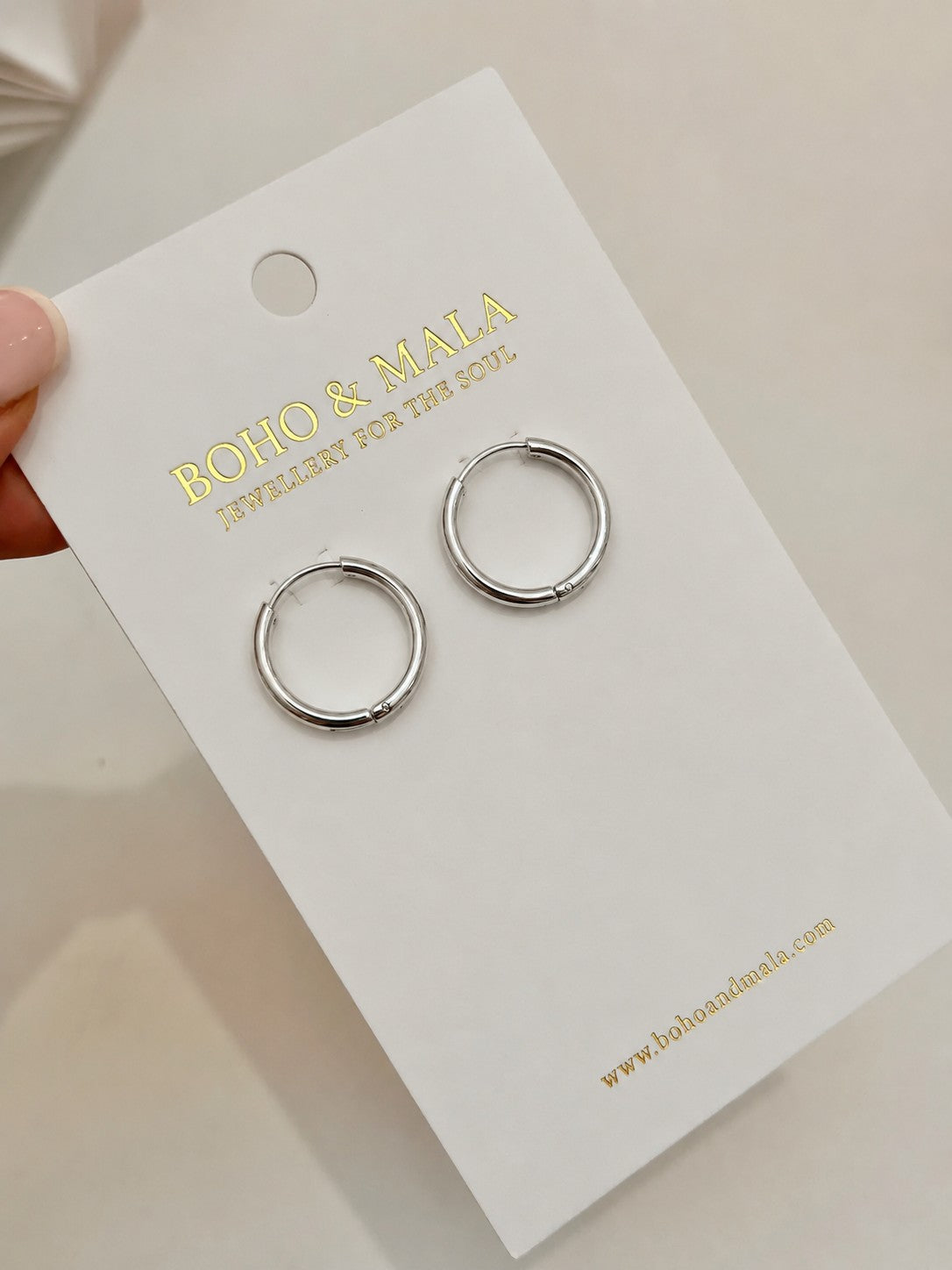 
                  
                    Silver chunky hoop earrings on Boho & Mala packaging card
                  
                