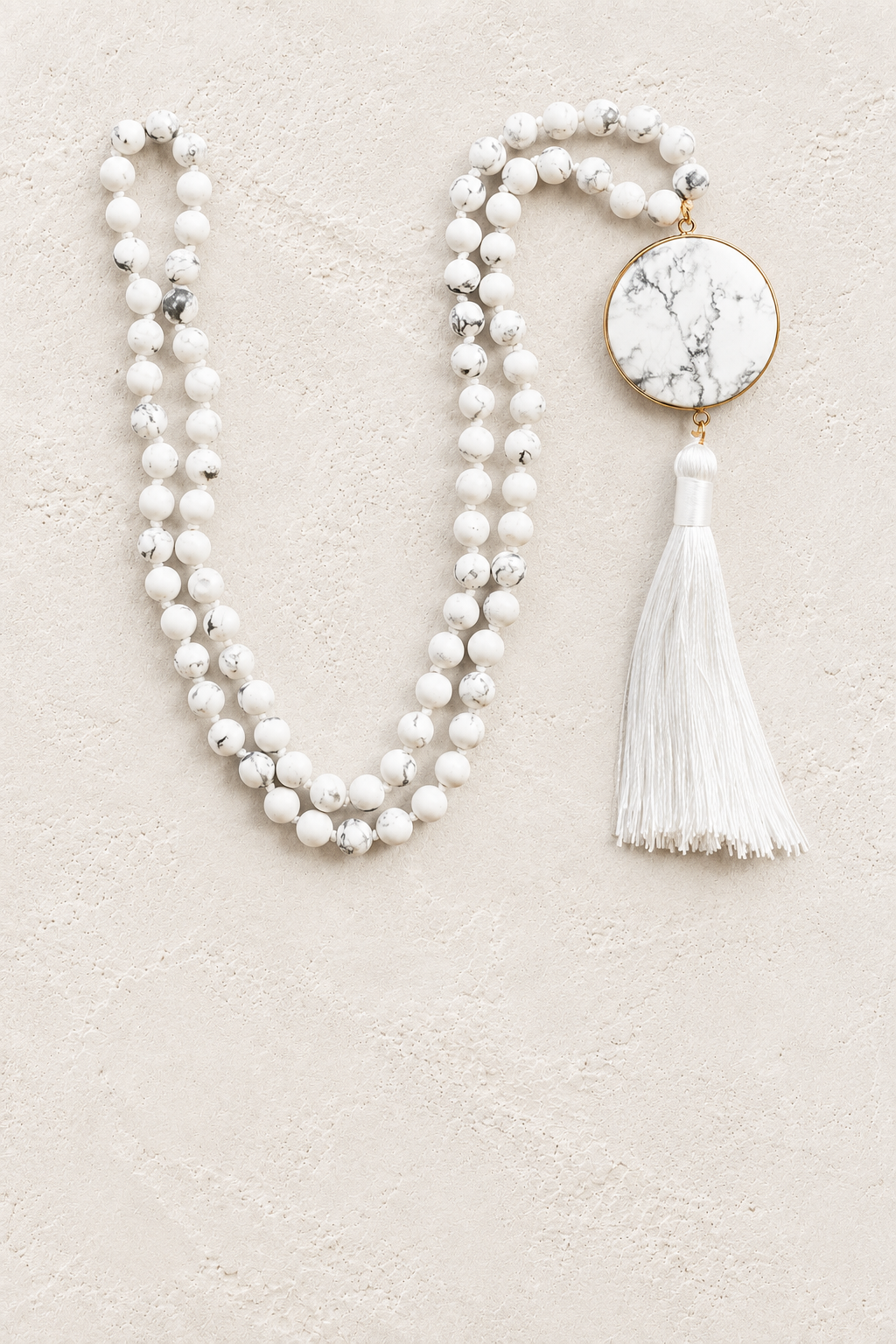
                  
                    Howlite Tassel Necklace on warm ivory plaster background
                  
                