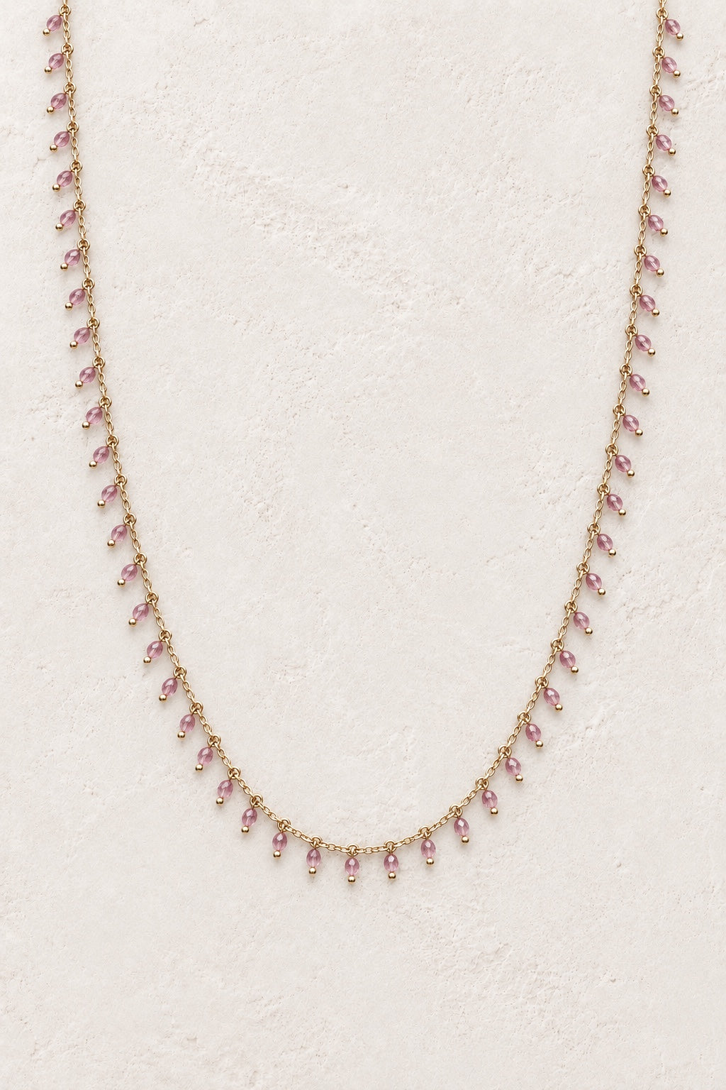 Isolde Rose Quartz gemstone drop necklace on a light neutral background