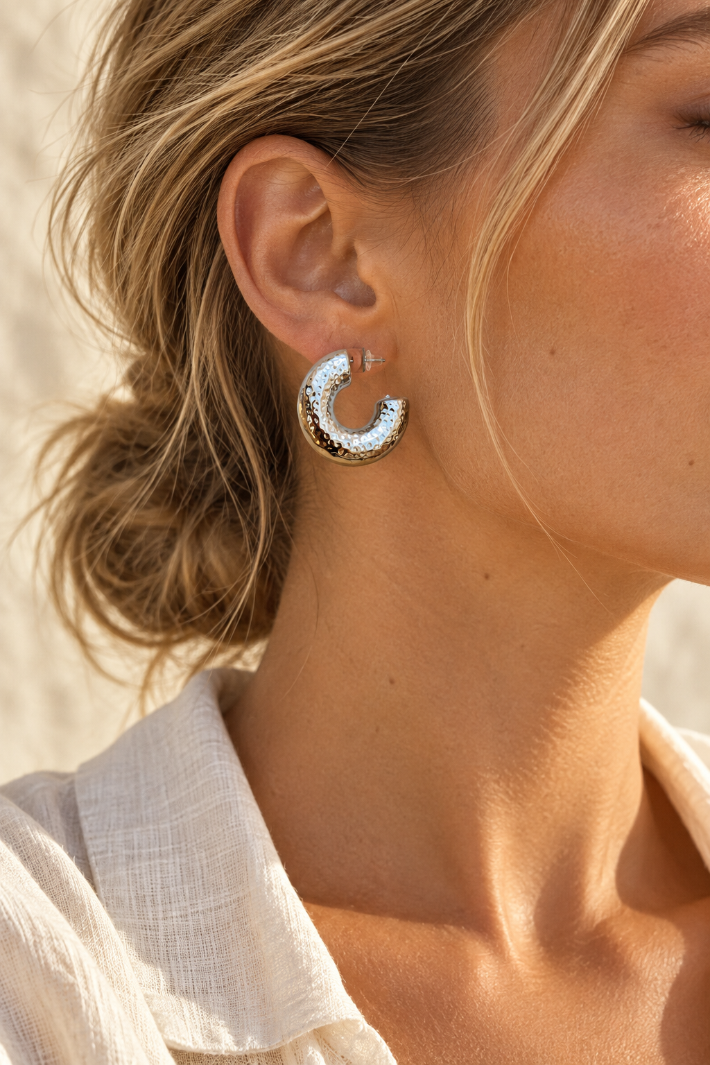 Model wearing Kaia hammered silver hoop earring