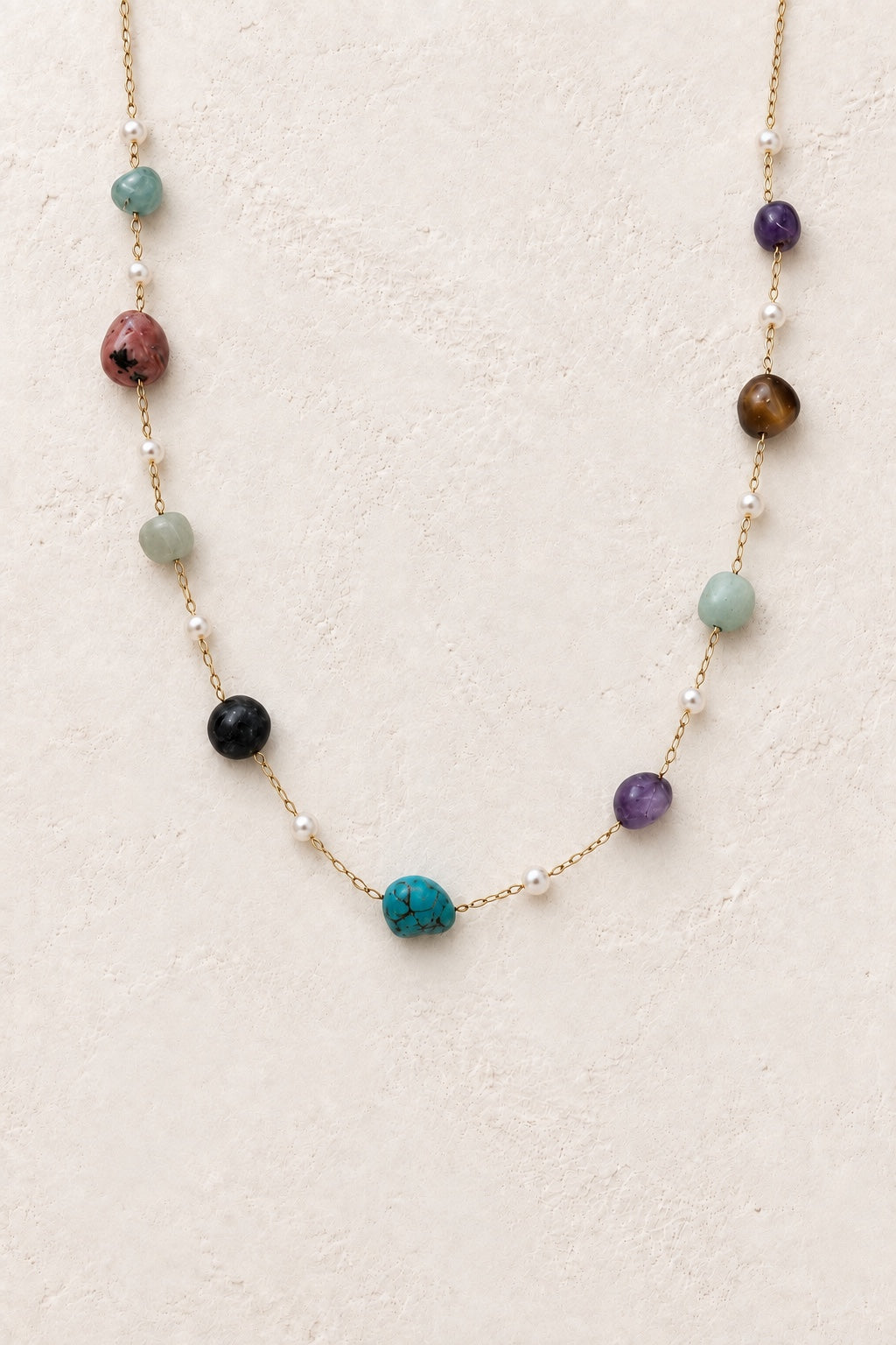 
                  
                    Kaleida Mixed Stone and pearl-accent necklace on a neutral background
                  
                