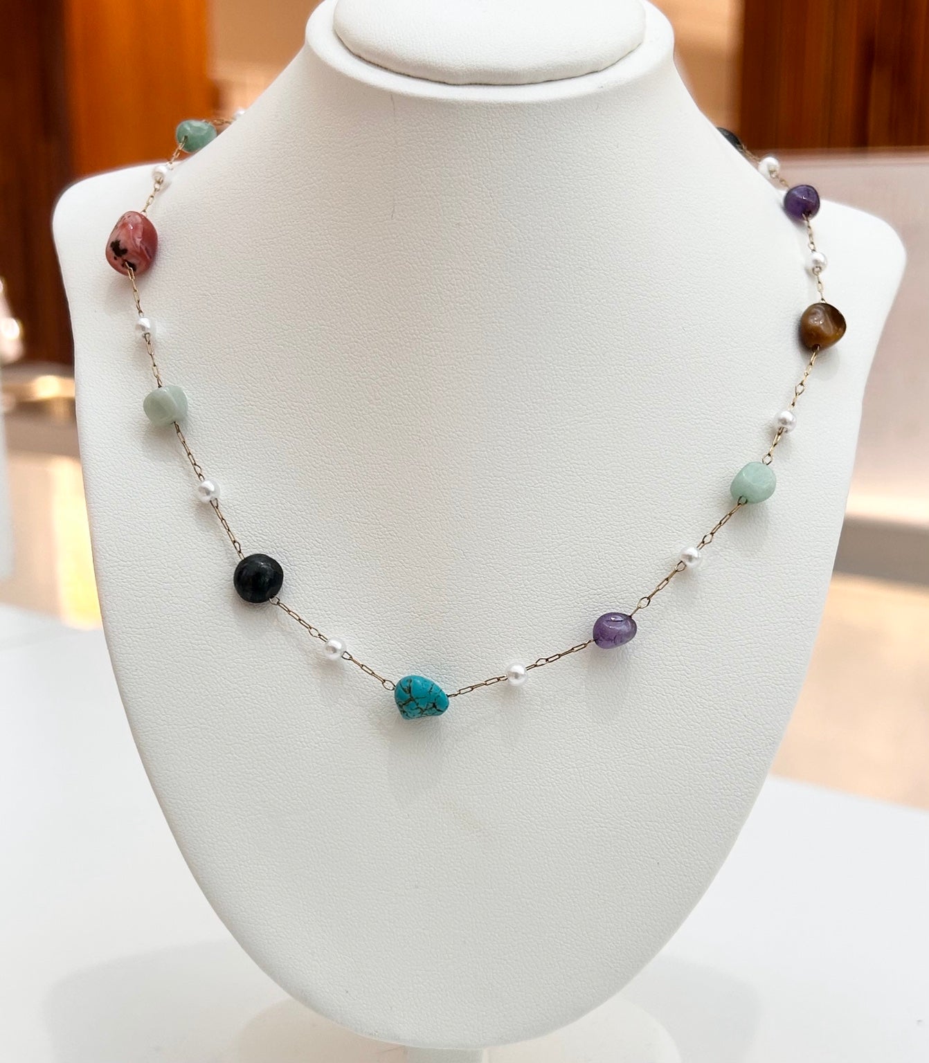 
                  
                    Kaleida Mixed Stone tarnish-free necklace displayed on a jewellery bust
                  
                