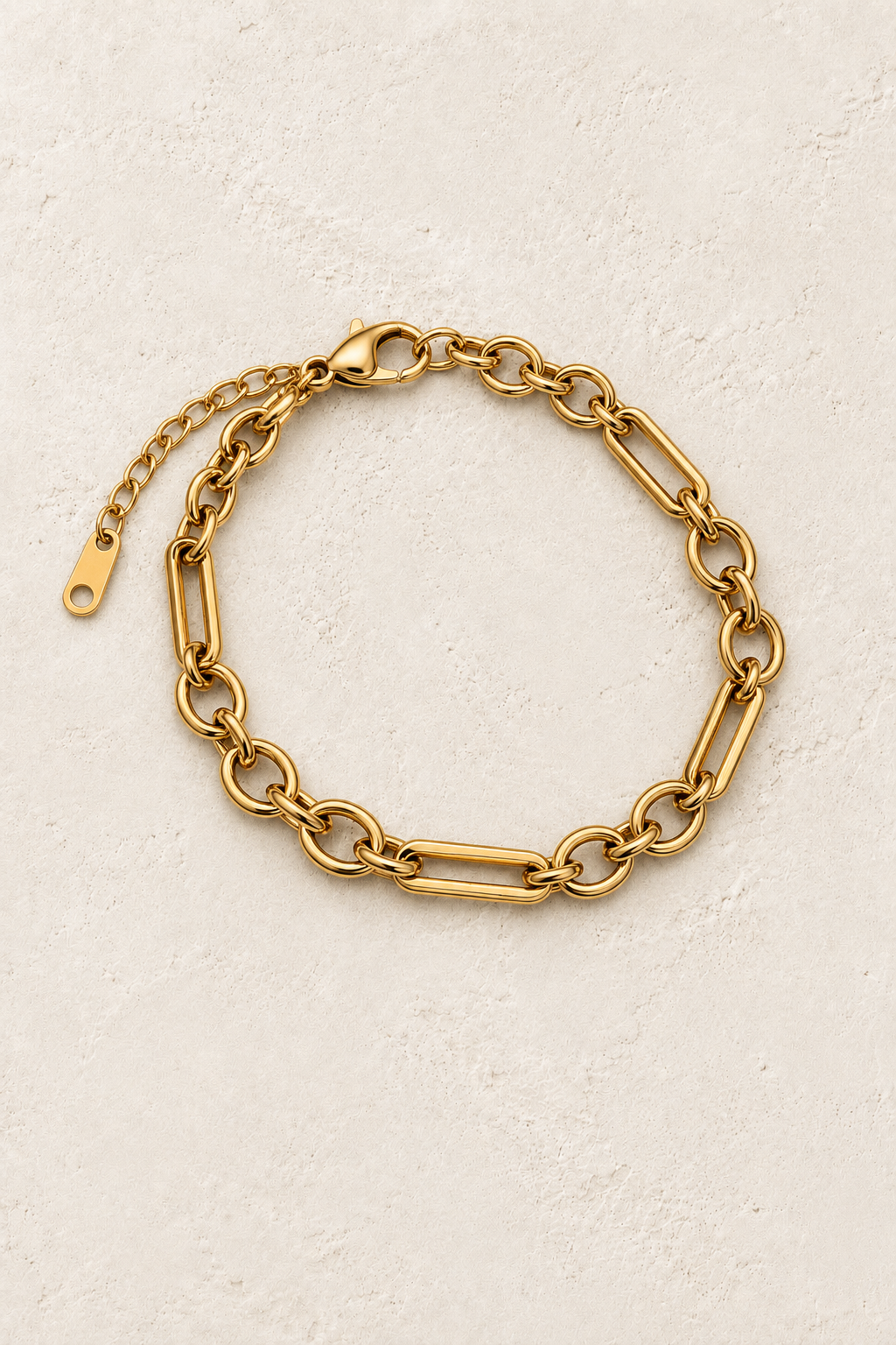 Lisette Gold Mixed Link Bracelet on cream beige textured background