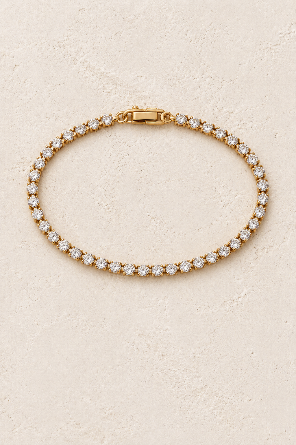 Luciana Gold Classic Crystal Tennis Bracelet on a beige textured background