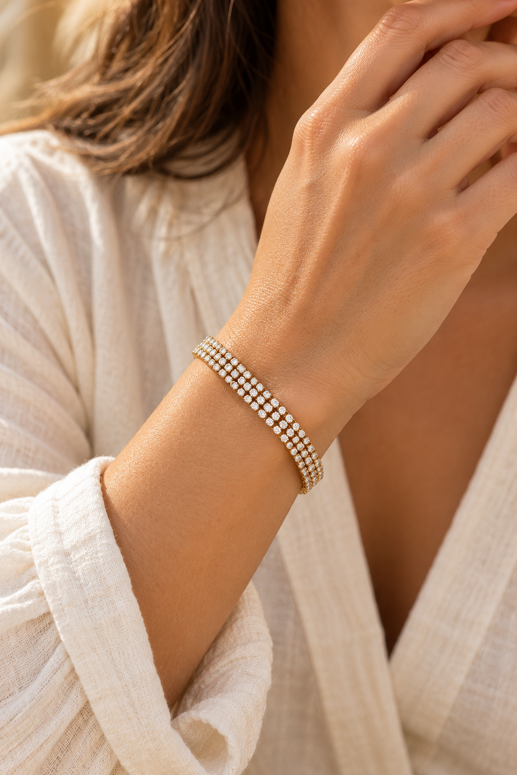 
                  
                    Luciana Gold Triple Row Crystal Tennis Bracelet worn on a model's wrist
                  
                