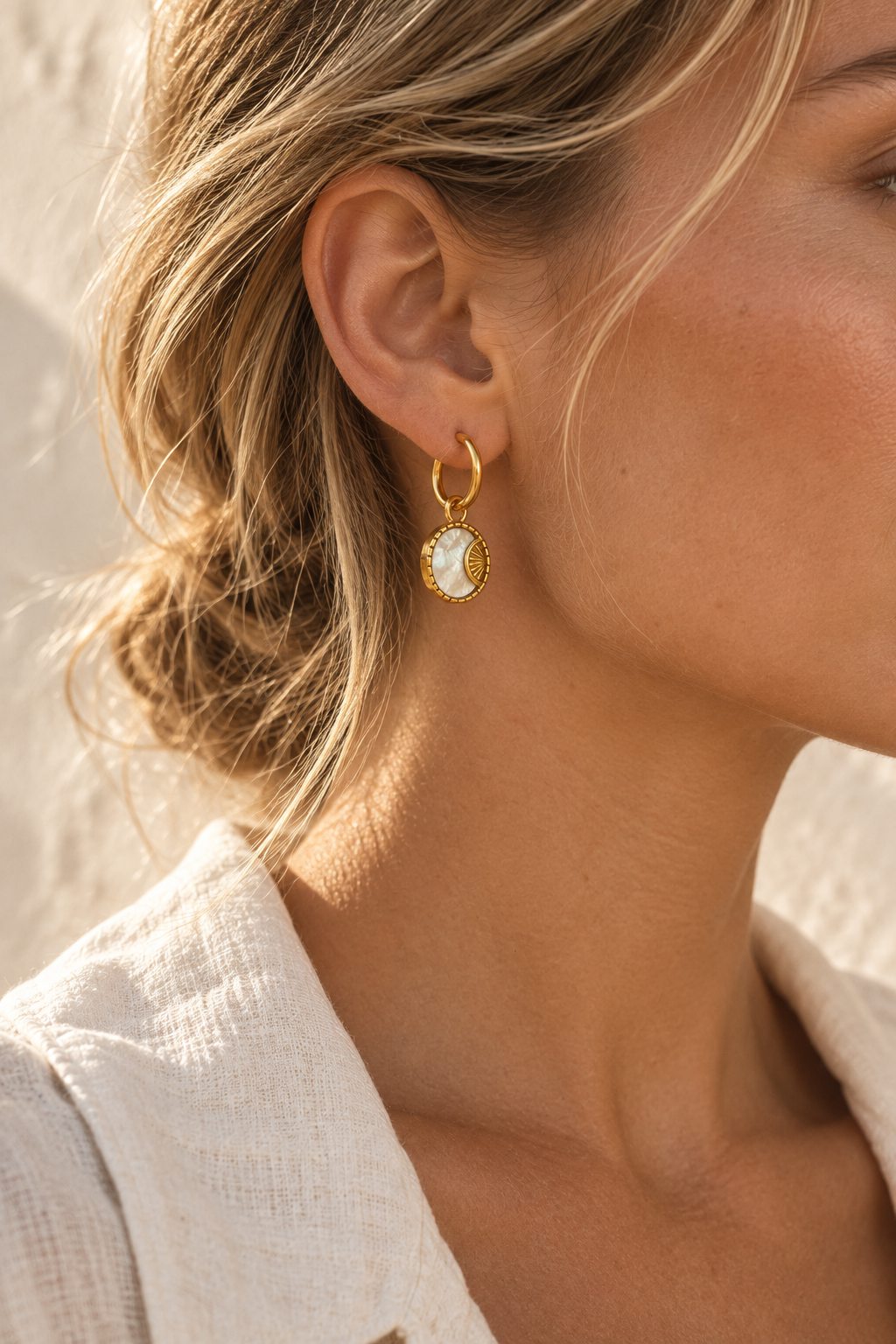 Model wearing Luna shell medallion hoop earring