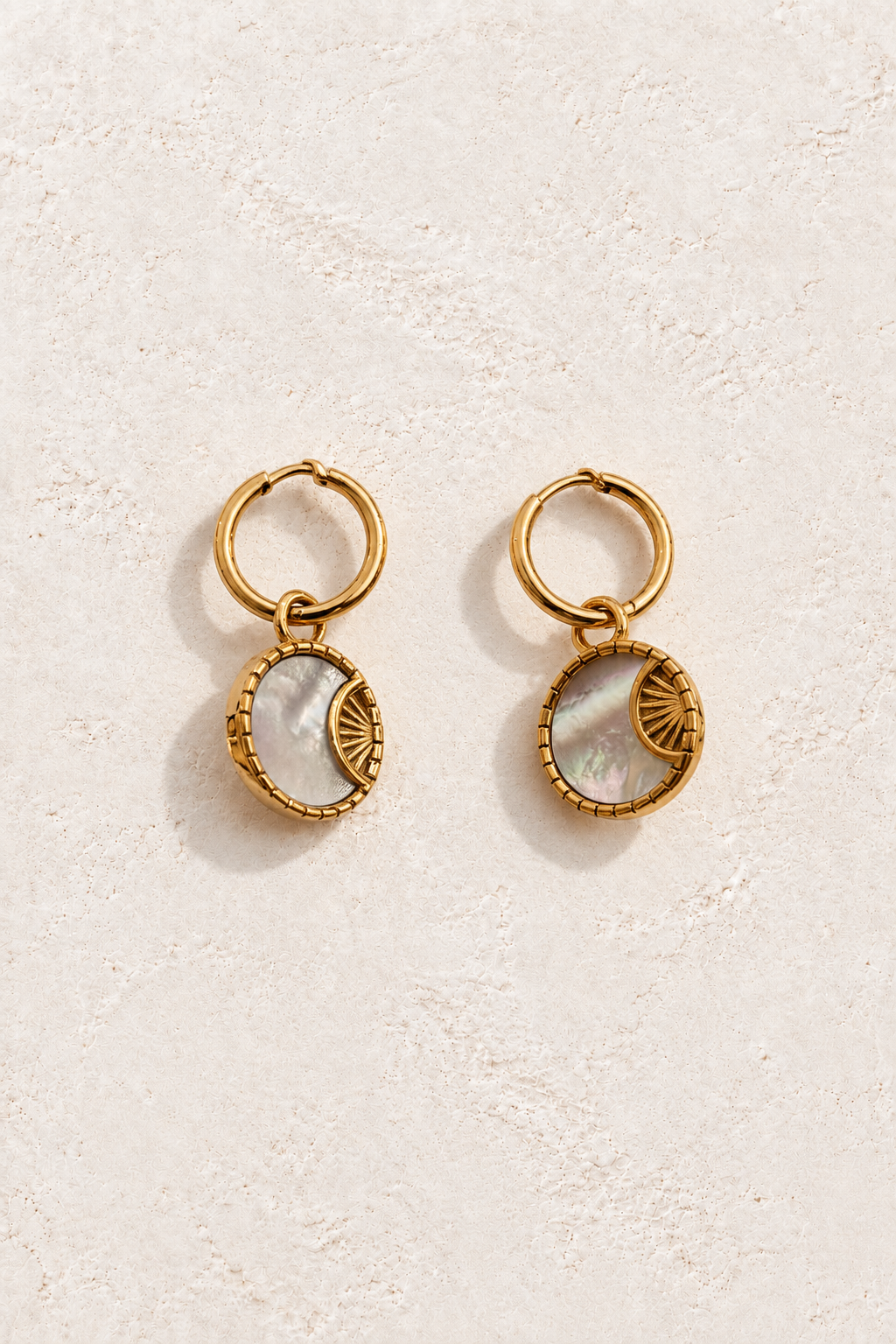 Luna Shell Medallion Hoops on warm ivory textured background