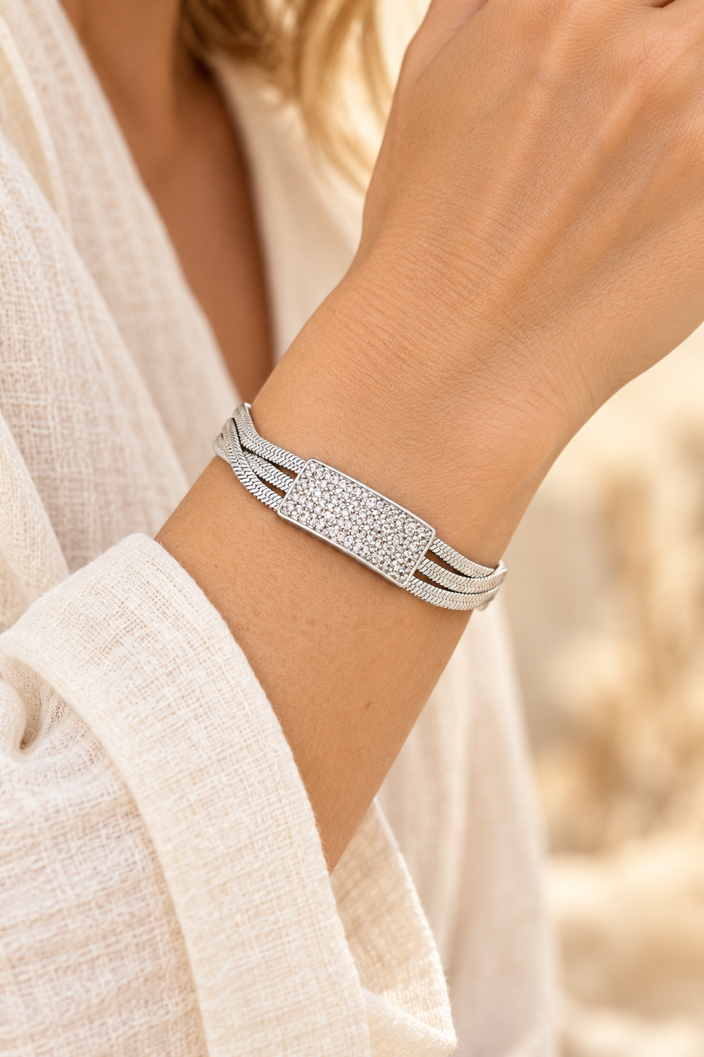 
                  
                    Luxe Pavé Bar Silver Snake Chain Bracelet worn on a model's wrist
                  
                