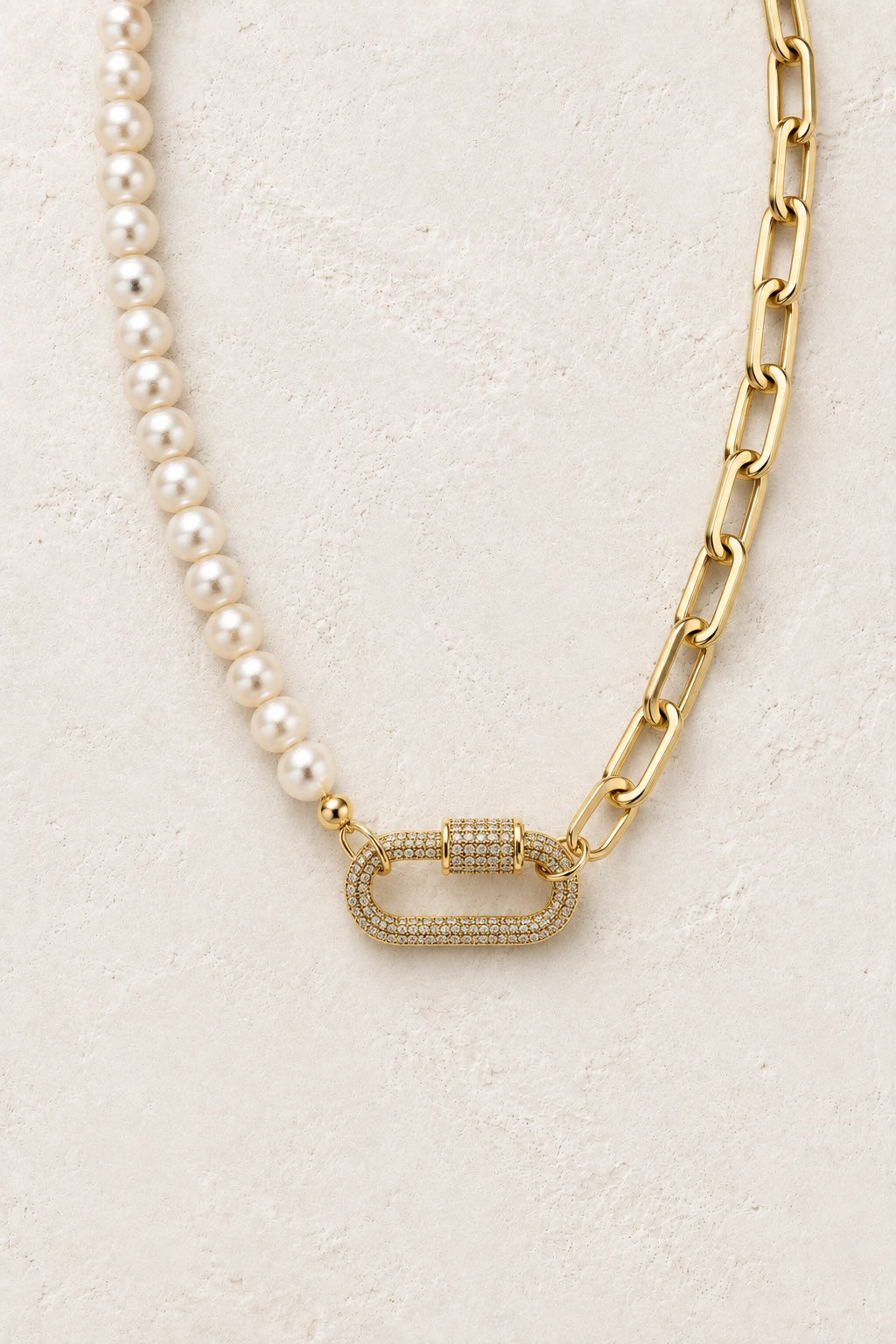 Marielle freshwater pearl and gold link necklace with pavé clasp on a neutral background