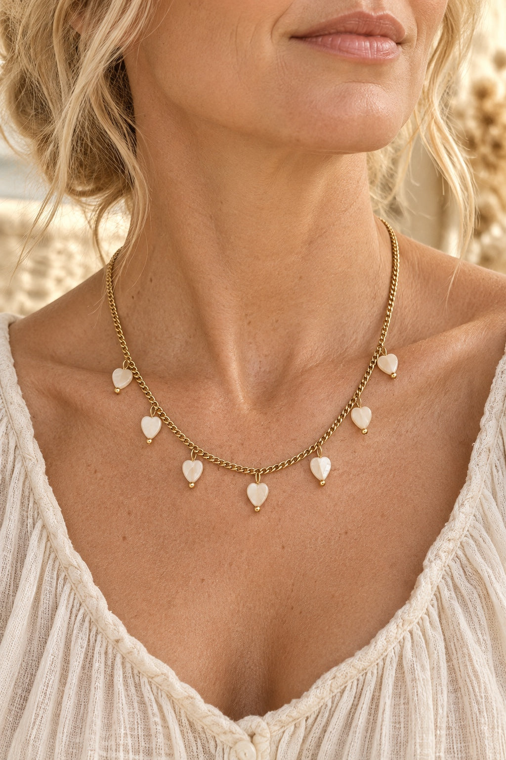 Boho model wearing the Marielle shell heart gold necklace