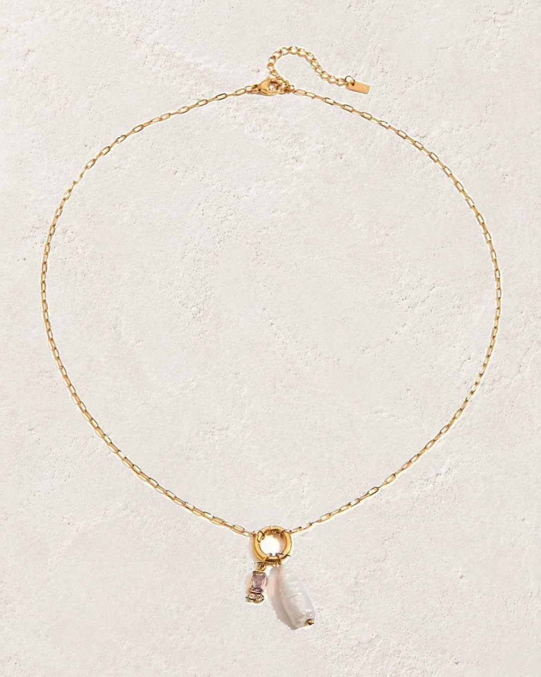 Marina Pearl June Alexandrite birthstone necklace on cream plaster background