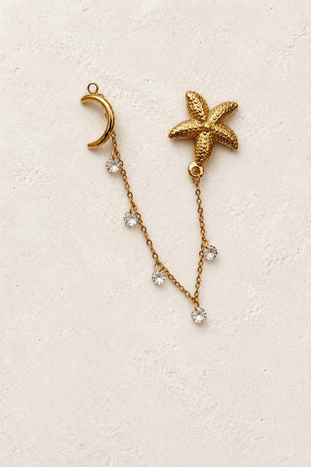 Marina Starfish Chain Crystal Earrings on cream plaster background