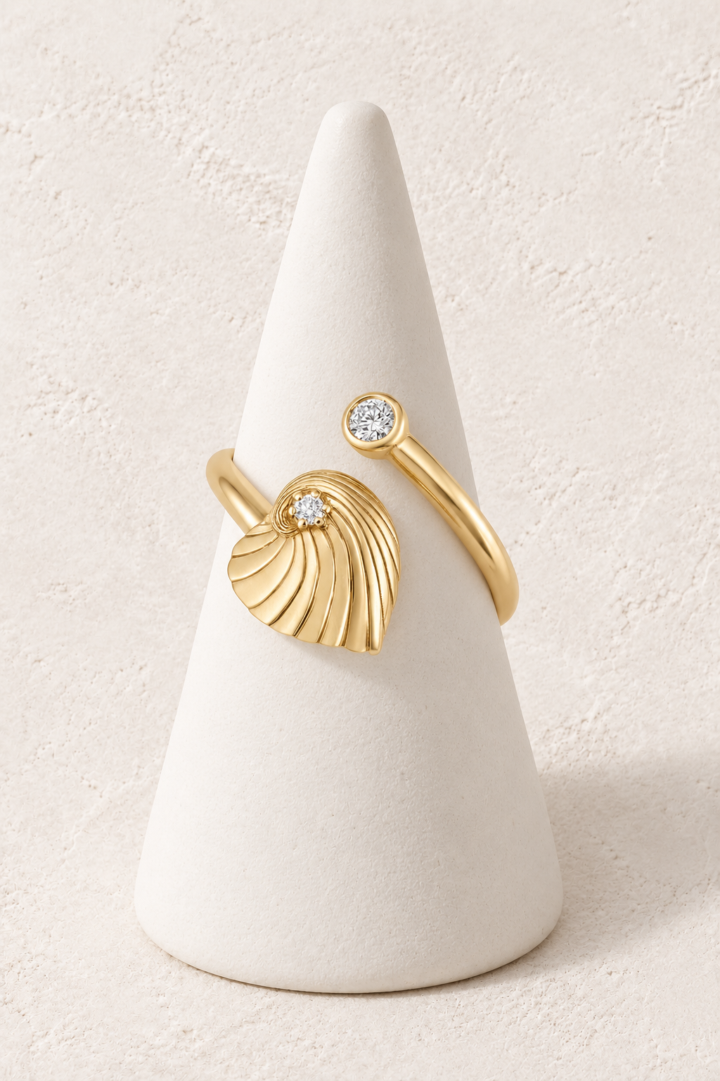 Maris Shell Crystal Ring on a white display cone against a warm textured background