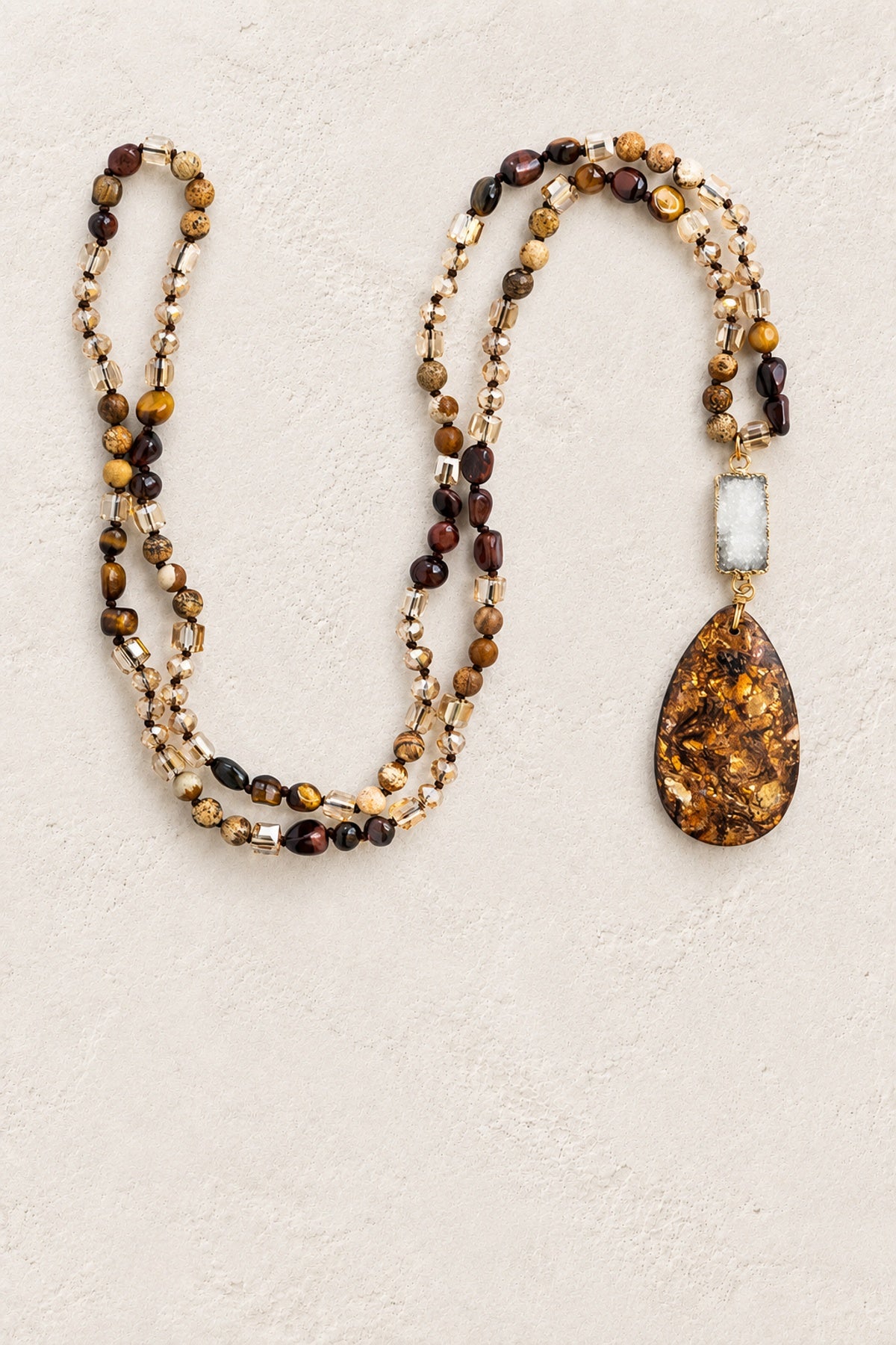 
                  
                    Mixed Agate Tribal Necklace II on warm cream plaster background
                  
                