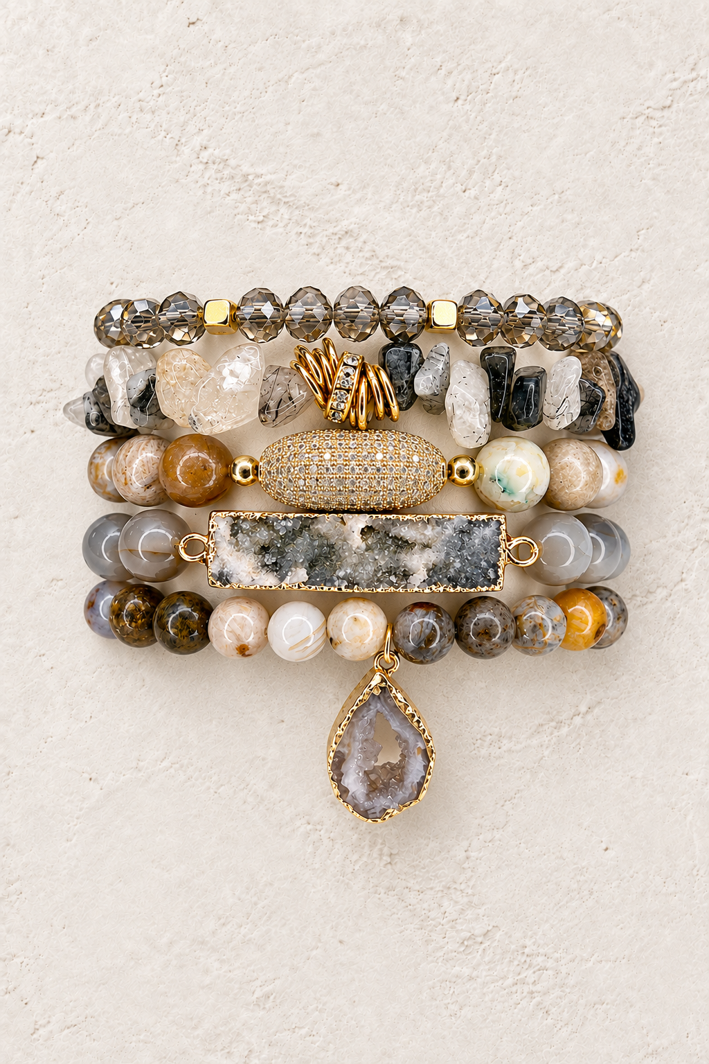 
                  
                    Moonstone Canyon five-piece neutral stone elastic bracelet stack on warm textured background
                  
                