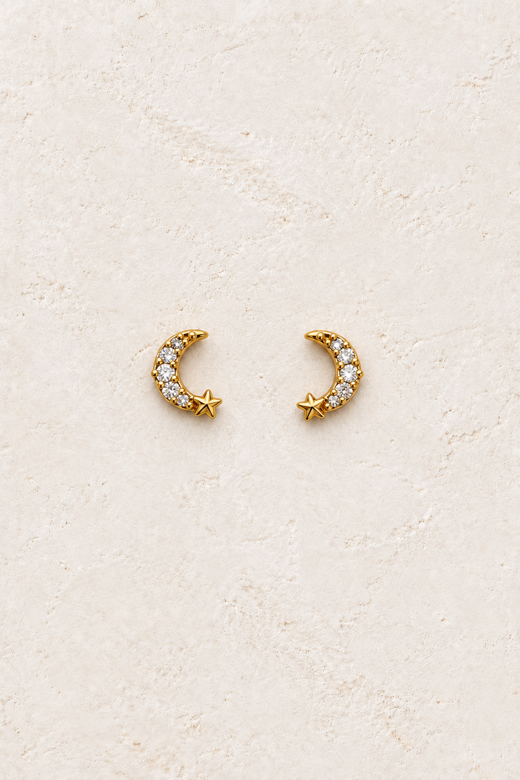 Neriah Pavé Moon & Star Studs on warm ivory textured background