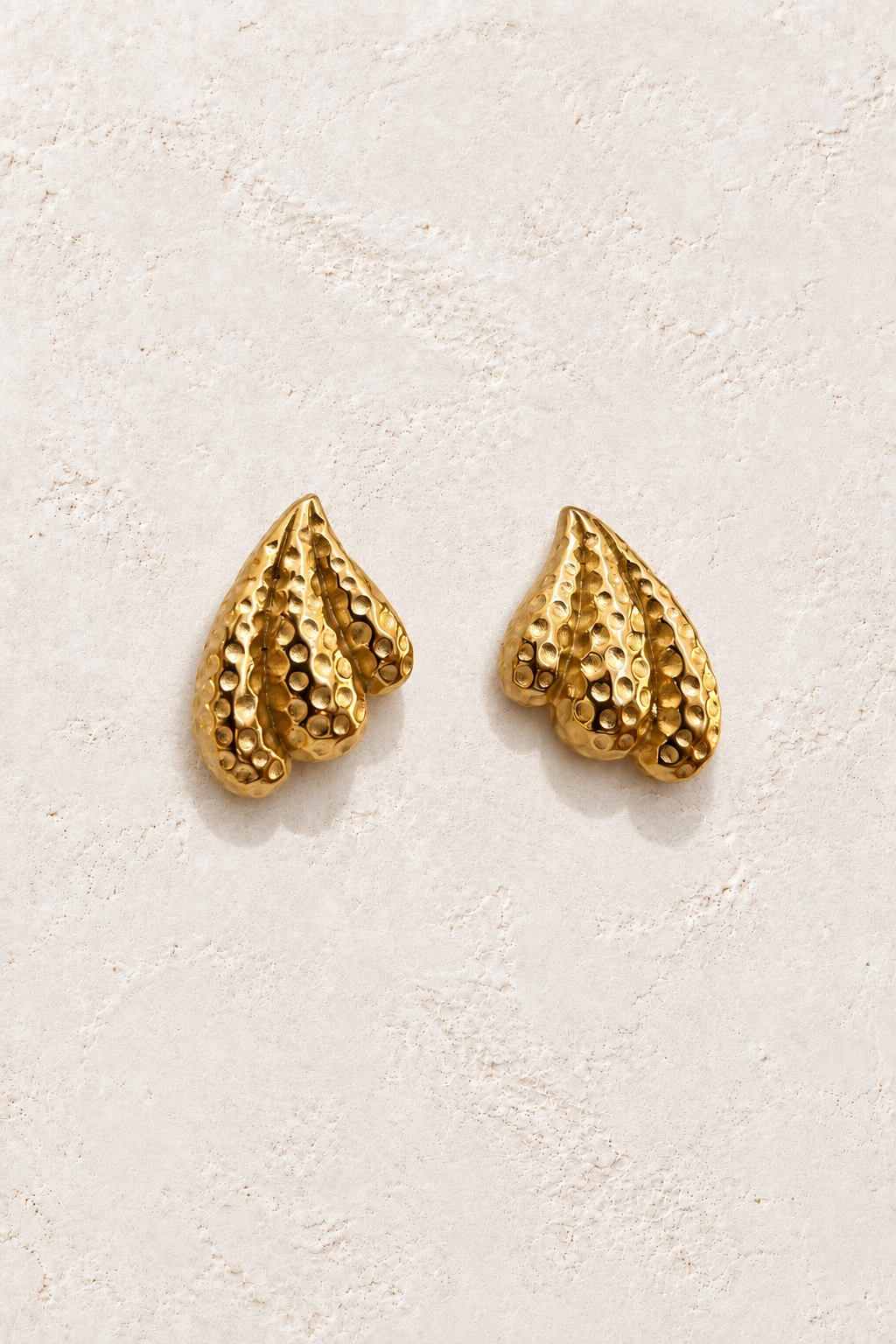Nerida Textured Shell Studs on warm ivory textured background