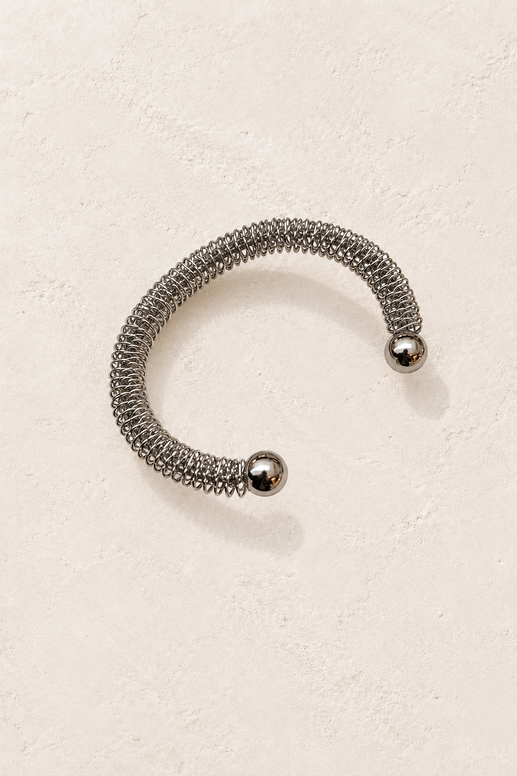 
                  
                    Nerina Silver Mesh Cuff on cream beige textured background
                  
                