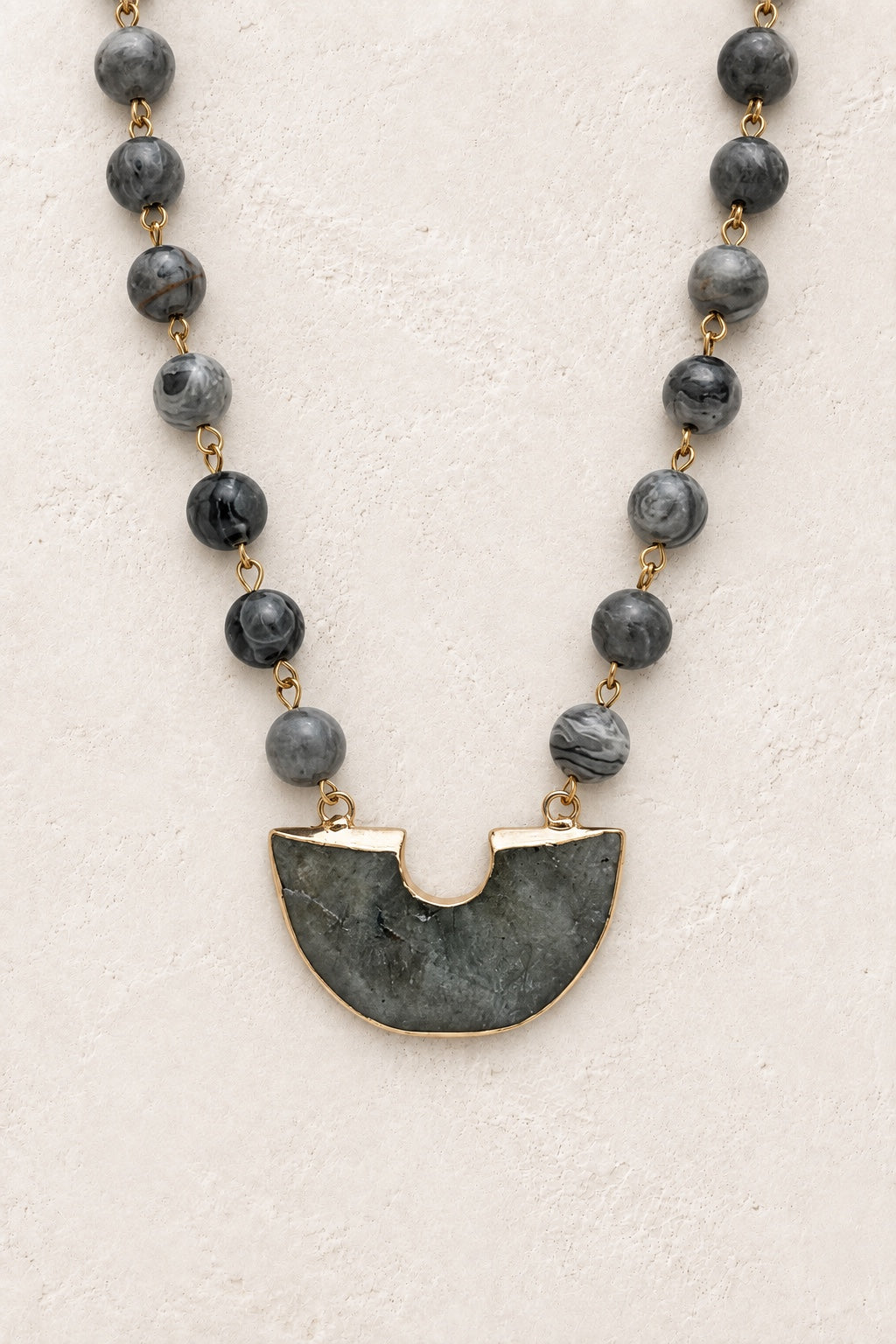 Noctara Labradorite beaded half-moon statement necklace on a neutral background