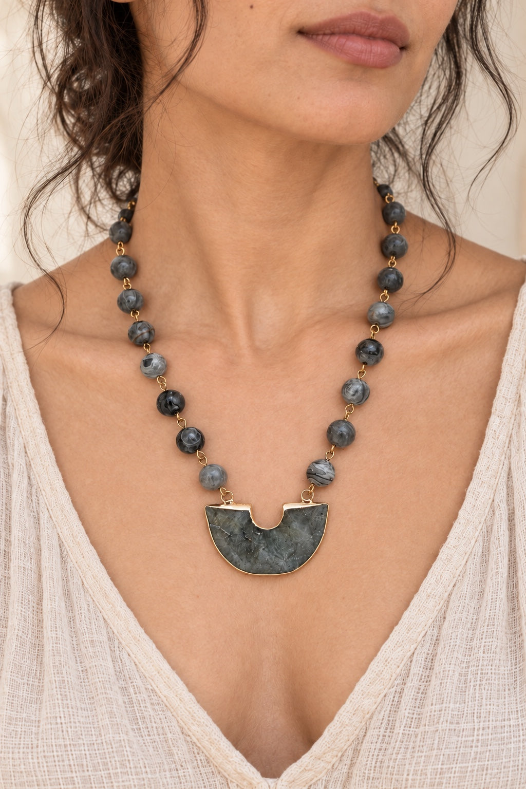 Boho model wearing the Noctara Labradorite half-moon statement necklace