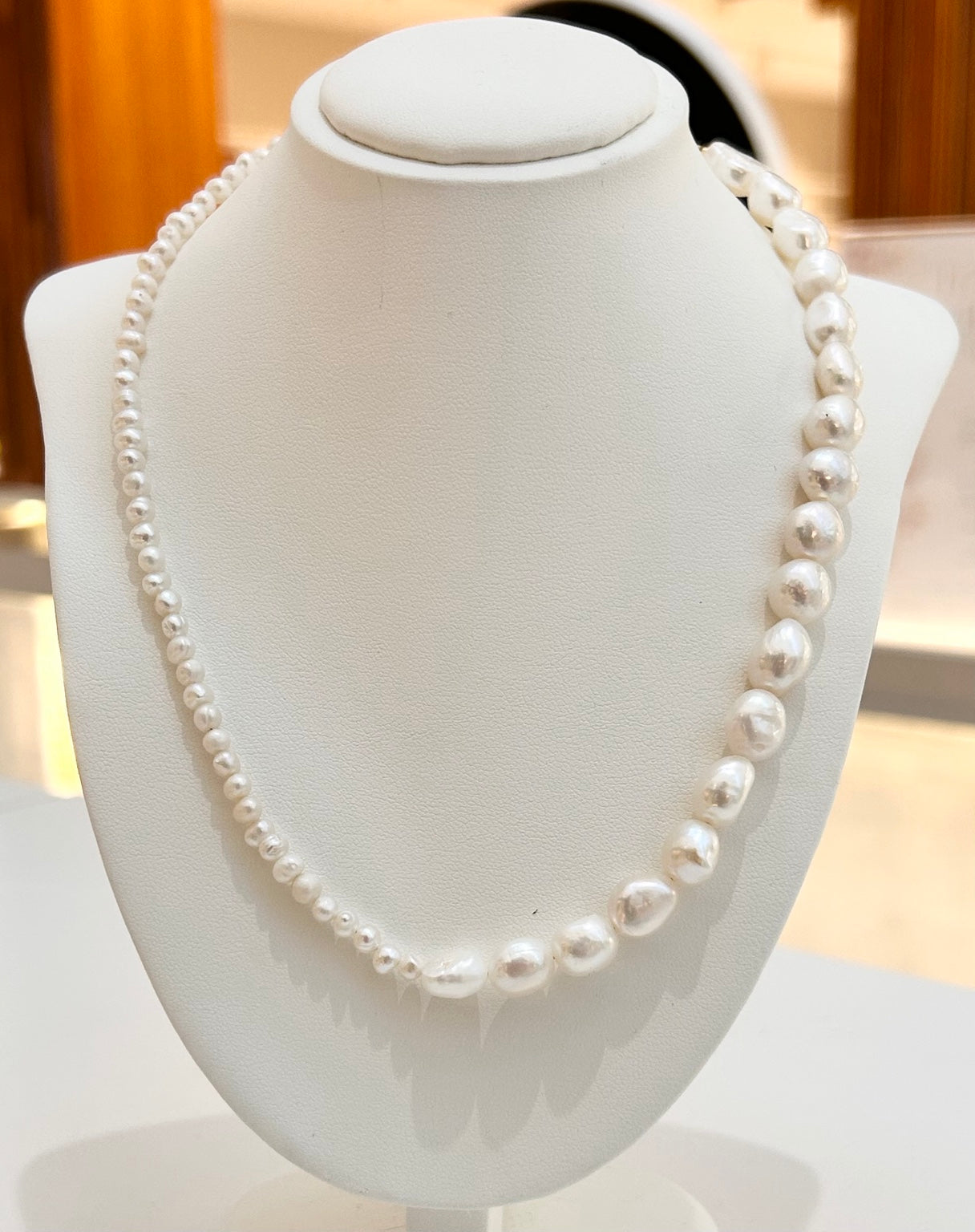 
                  
                    Odette asymmetric freshwater pearl necklace displayed on a jewellery bust
                  
                