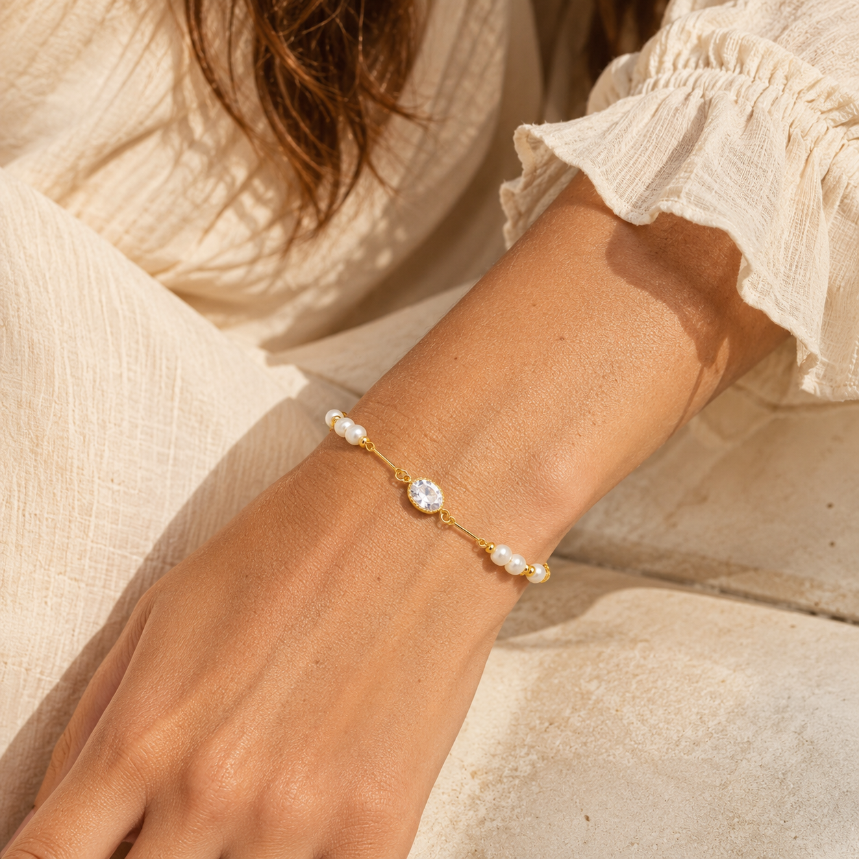 Odette oval crystal and freshwater pearl bracelet worn on boho model
