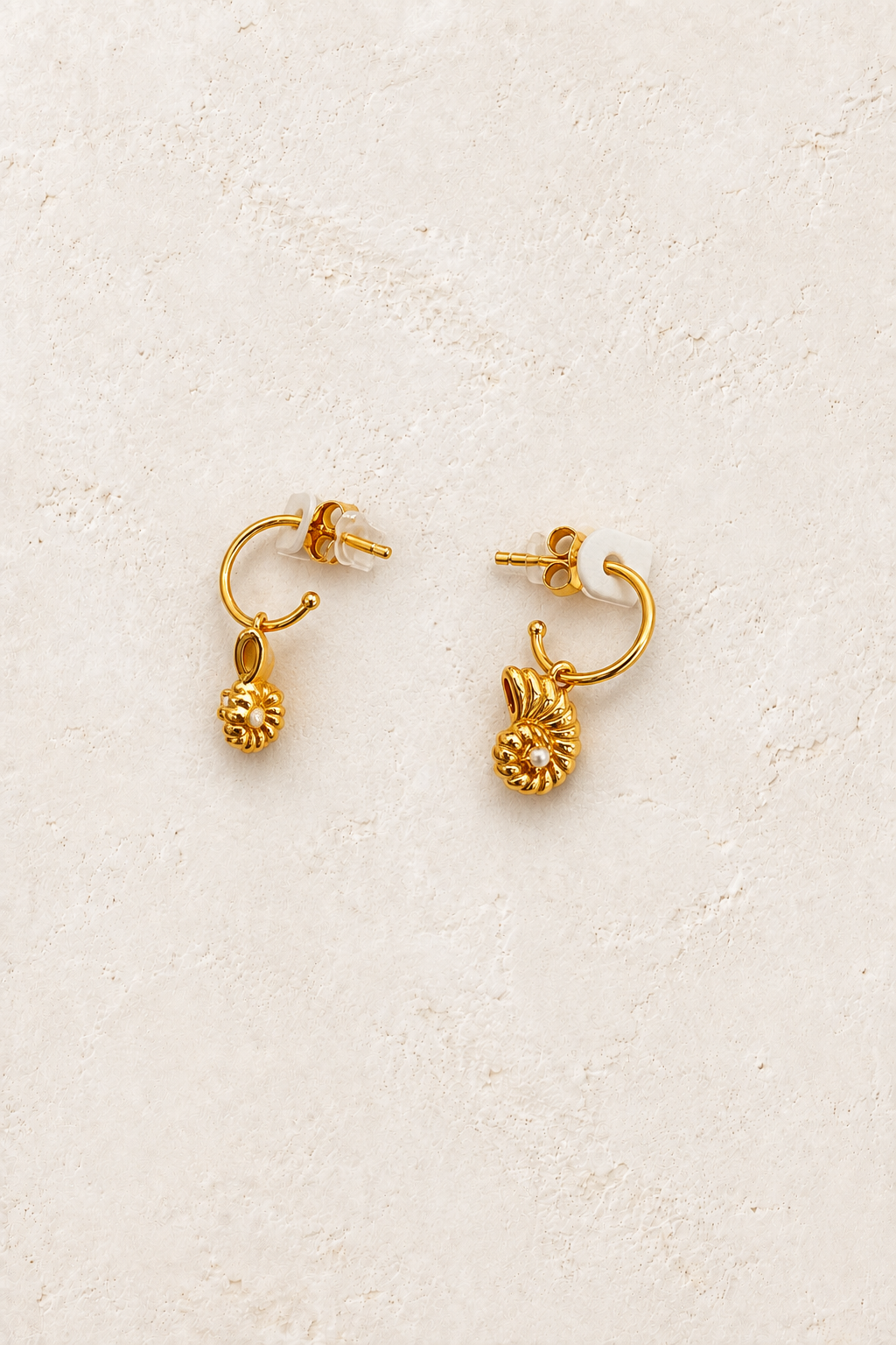 Ondine Shell Charm Hoops on warm ivory textured background