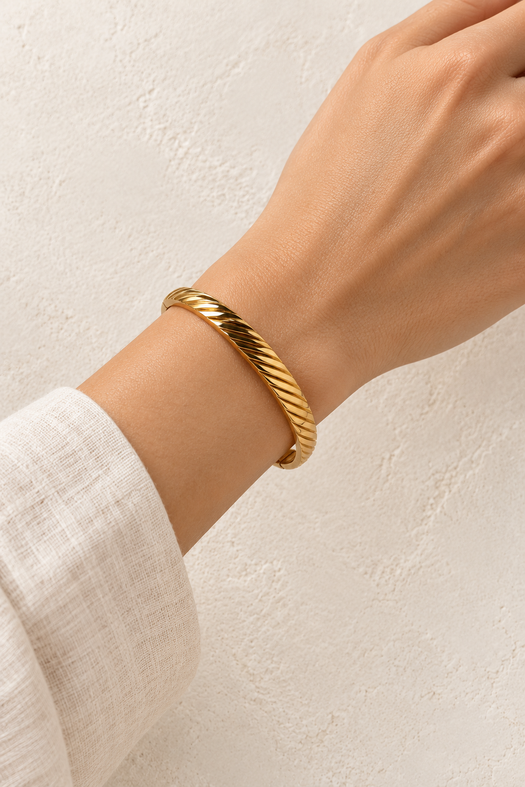 
                  
                    Model wearing Oriana Gold Sculpted Twist Bangle
                  
                
