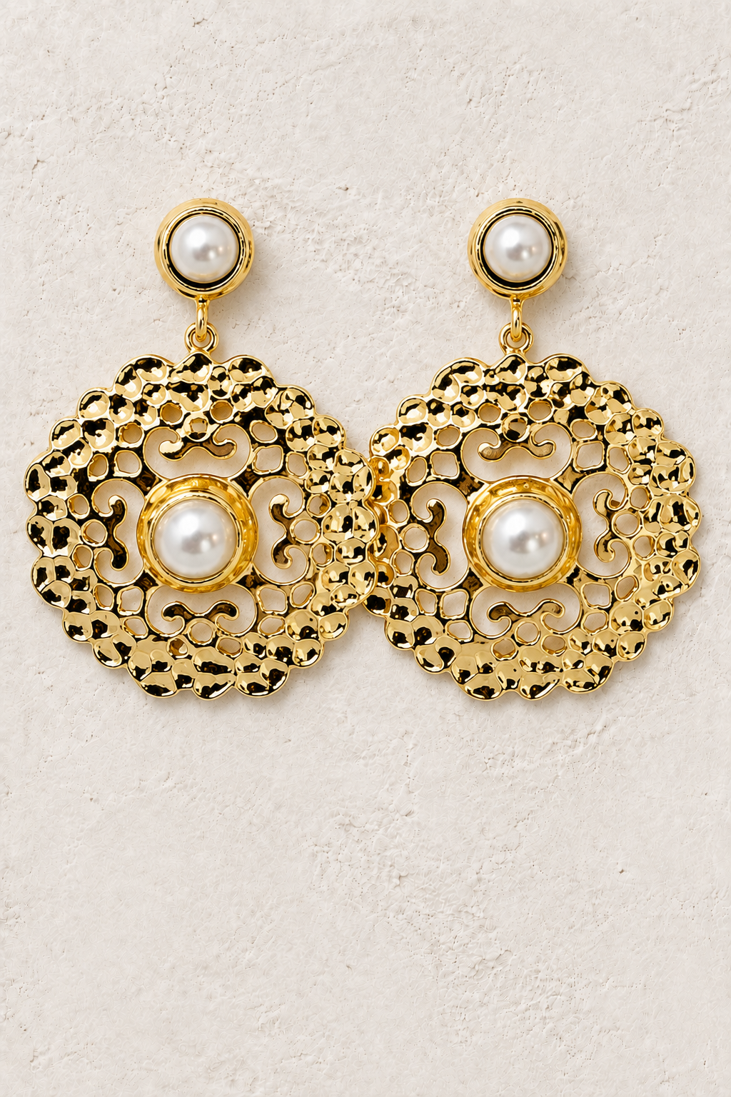 Pearl Arabesque gold filigree and pearl earrings on a warm textured background