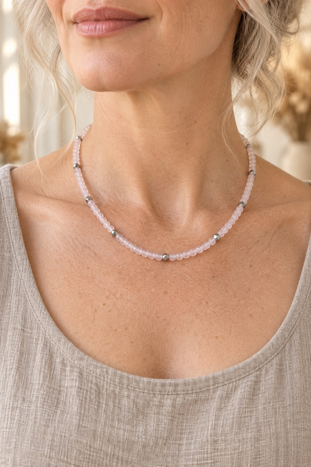 Model wearing the Rosalith Rose Quartz waterproof necklace