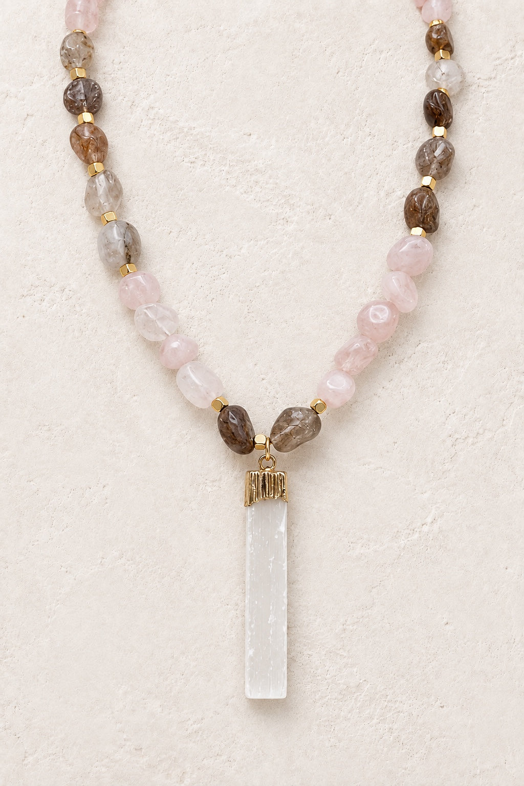 Rosamira mixed Rose Quartz necklace with selenite stick pendant on a neutral background