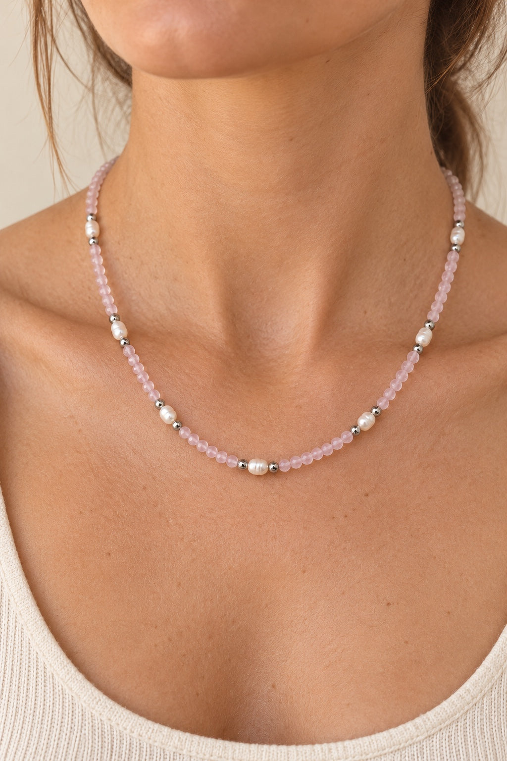 Boho model wearing the Rosavelle Rose Quartz silver-detail necklace