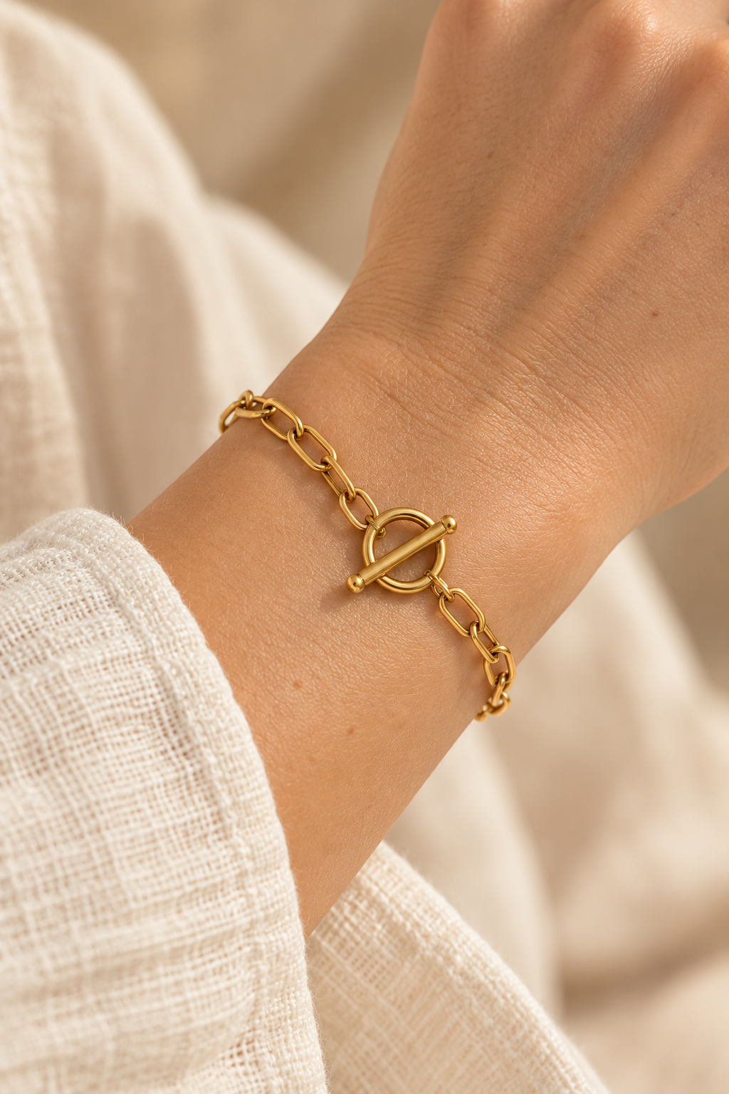 
                  
                    Sabine Gold Paperclip Toggle Bracelet worn on a model's wrist
                  
                