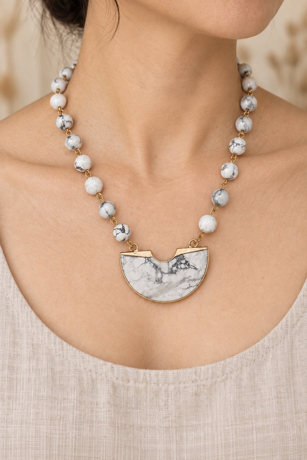 Boho model wearing the Savara White Howlite half-moon statement necklace