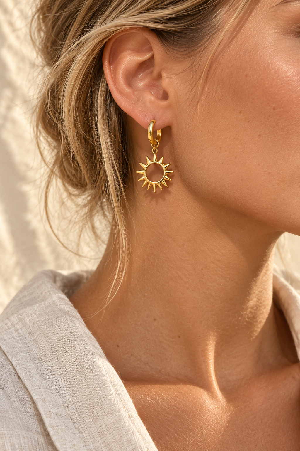 Model wearing Selene gold celestial sun hoop earring