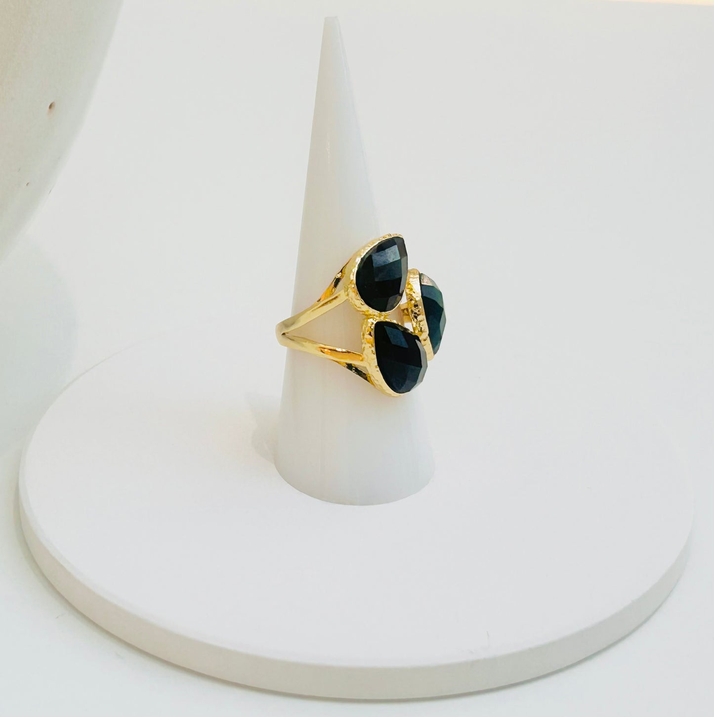 
                  
                    Seraphine Black Obsidian Statement Ring featuring three faceted black gemstones in a clustered gold-plated design by Boho & Mala.
                  
                