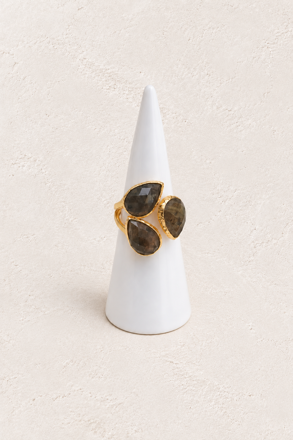 Seraphine Labradorite Adjustable Ring on warm ivory plaster background