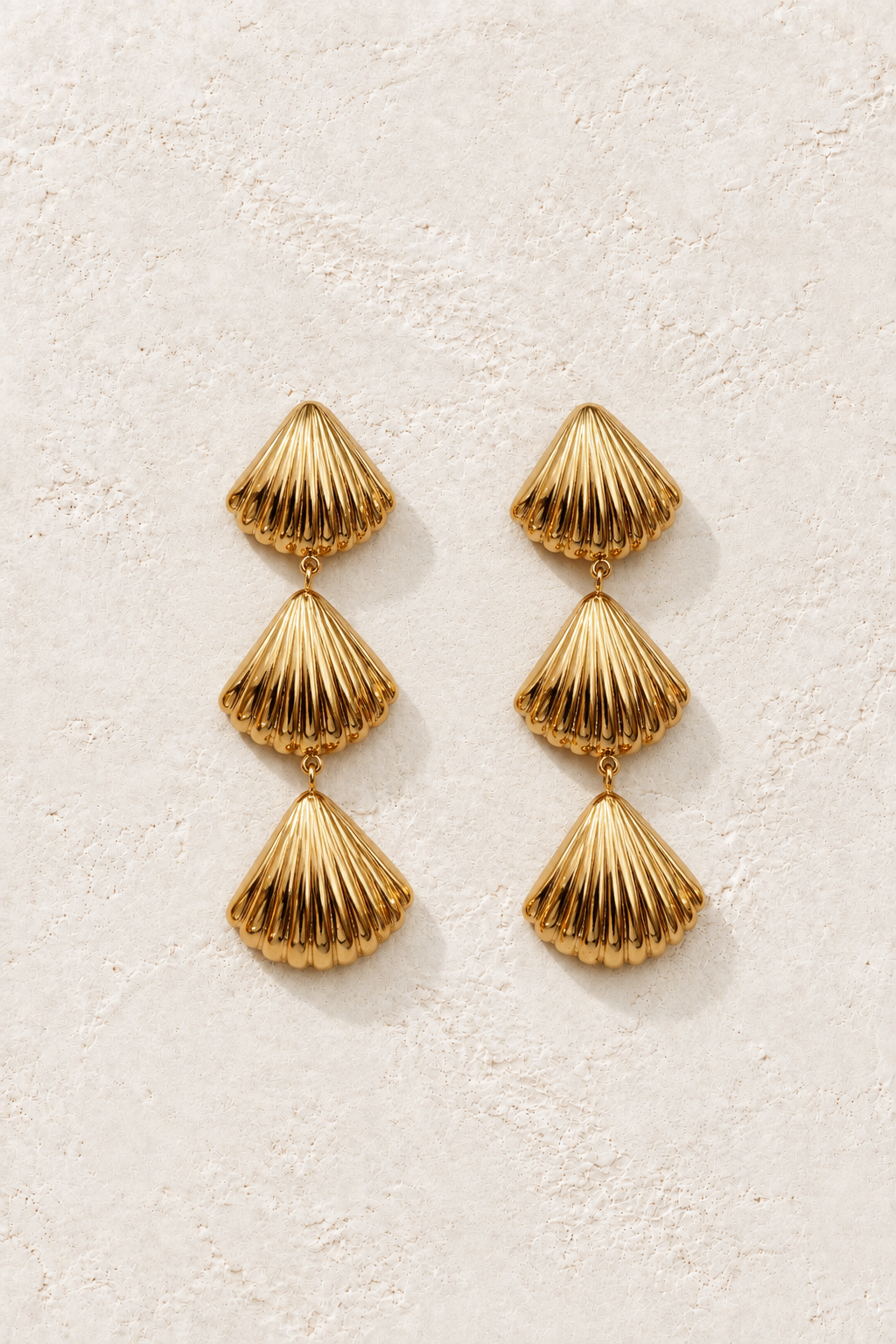 Sereia Triple Shell Drops on warm ivory textured background