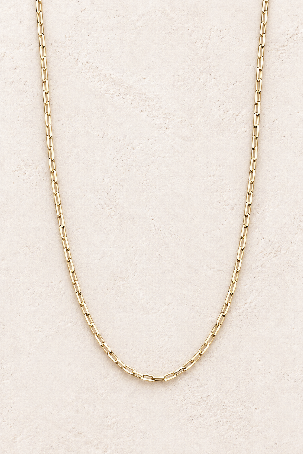 Seren Gold Link Necklace on warm ivory textured background