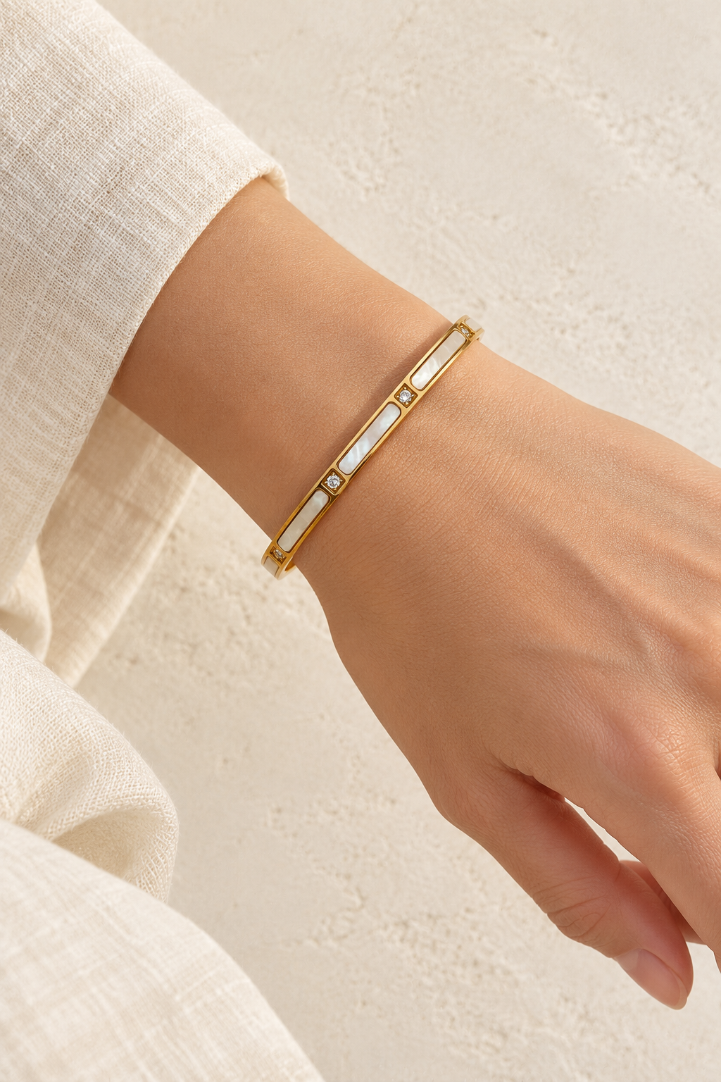 Model wearing Sola Gold Pearl Shell Crystal Bangle