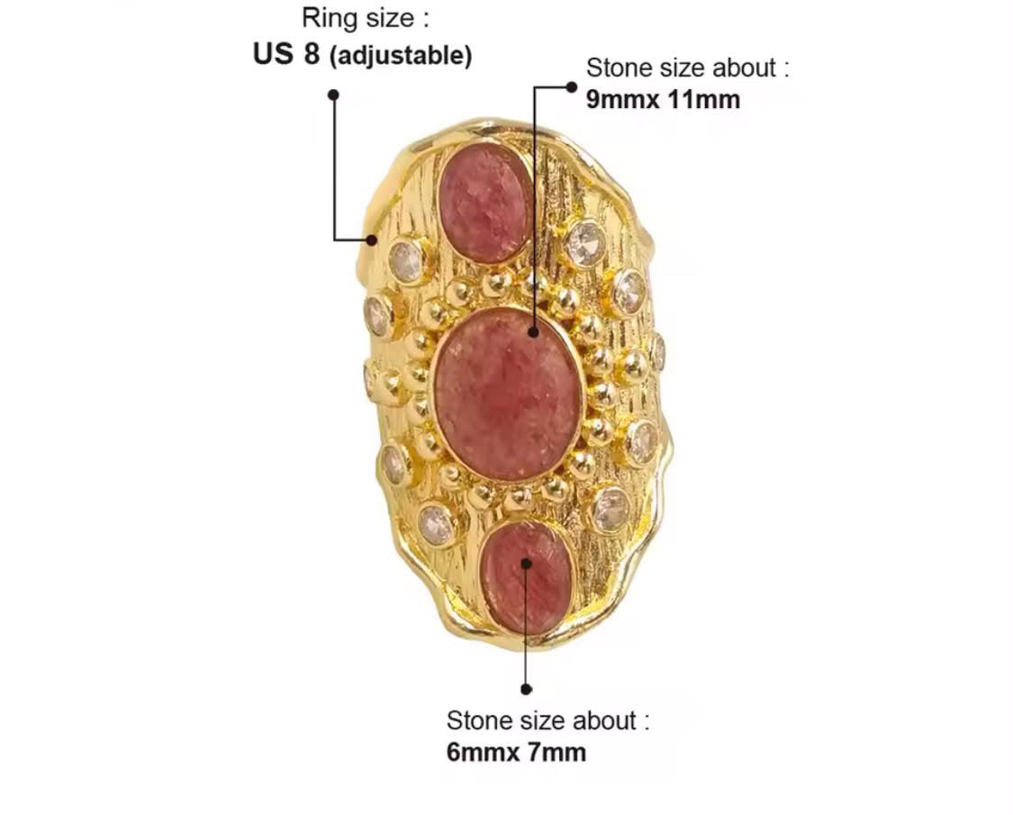 
                  
                    A gold ring with three oval pinkish-red stones and small clear stones, shown on a white background with measurement labels for ring size US 8 and stone sizes 9mmx11mm and 6mmx7mm.
                  
                