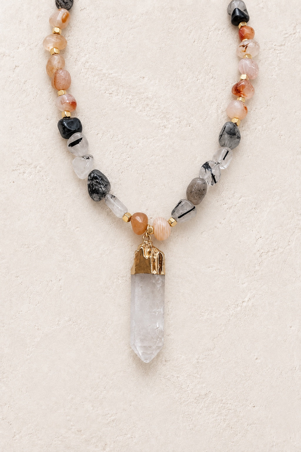 Sorelia mixed gemstone necklace with selenite stick pendant on a neutral background
