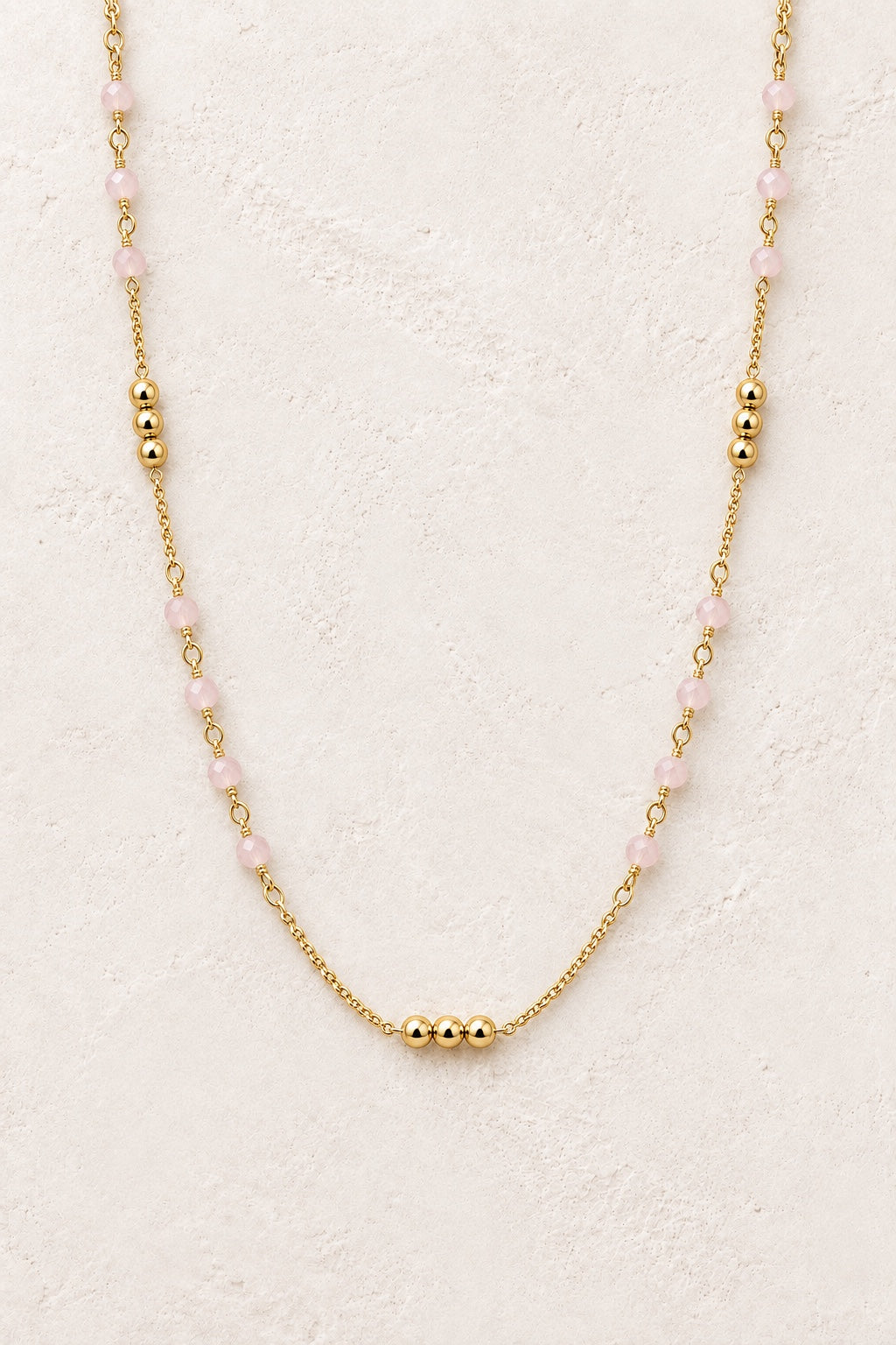 Sorella Rose Quartz and gold bead necklace on a neutral background